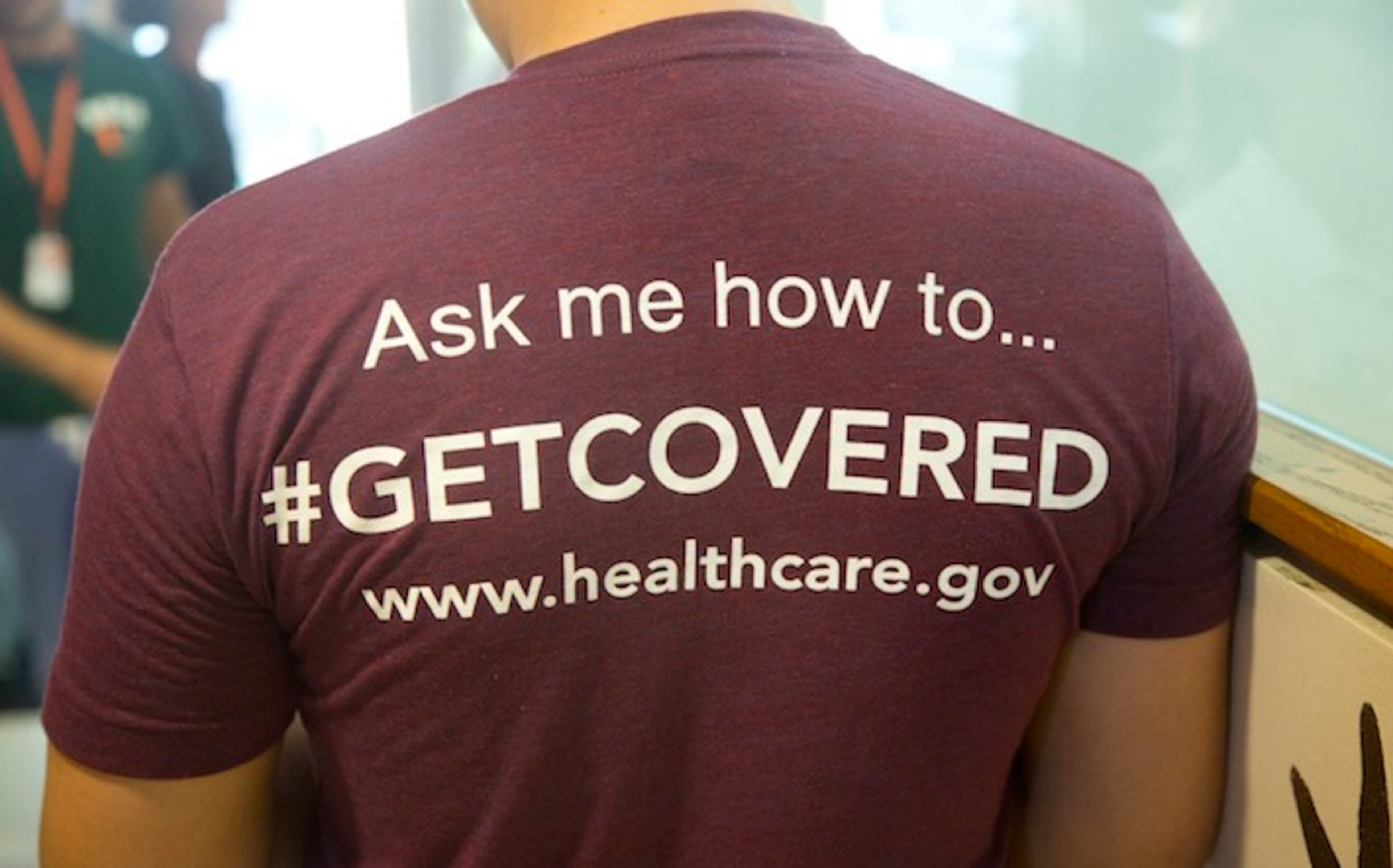 FILE - In this March 15, 2014 file photo,a volunteer health care worker wears a t-shirt, getting people to sign up for the new health care programs, in Miami. If Anthem withdraws from the Obamacare healthcare exchanges, it could create a vacuum in 96 Georgia counties. (AP Photo/J Pat Carter, File)
