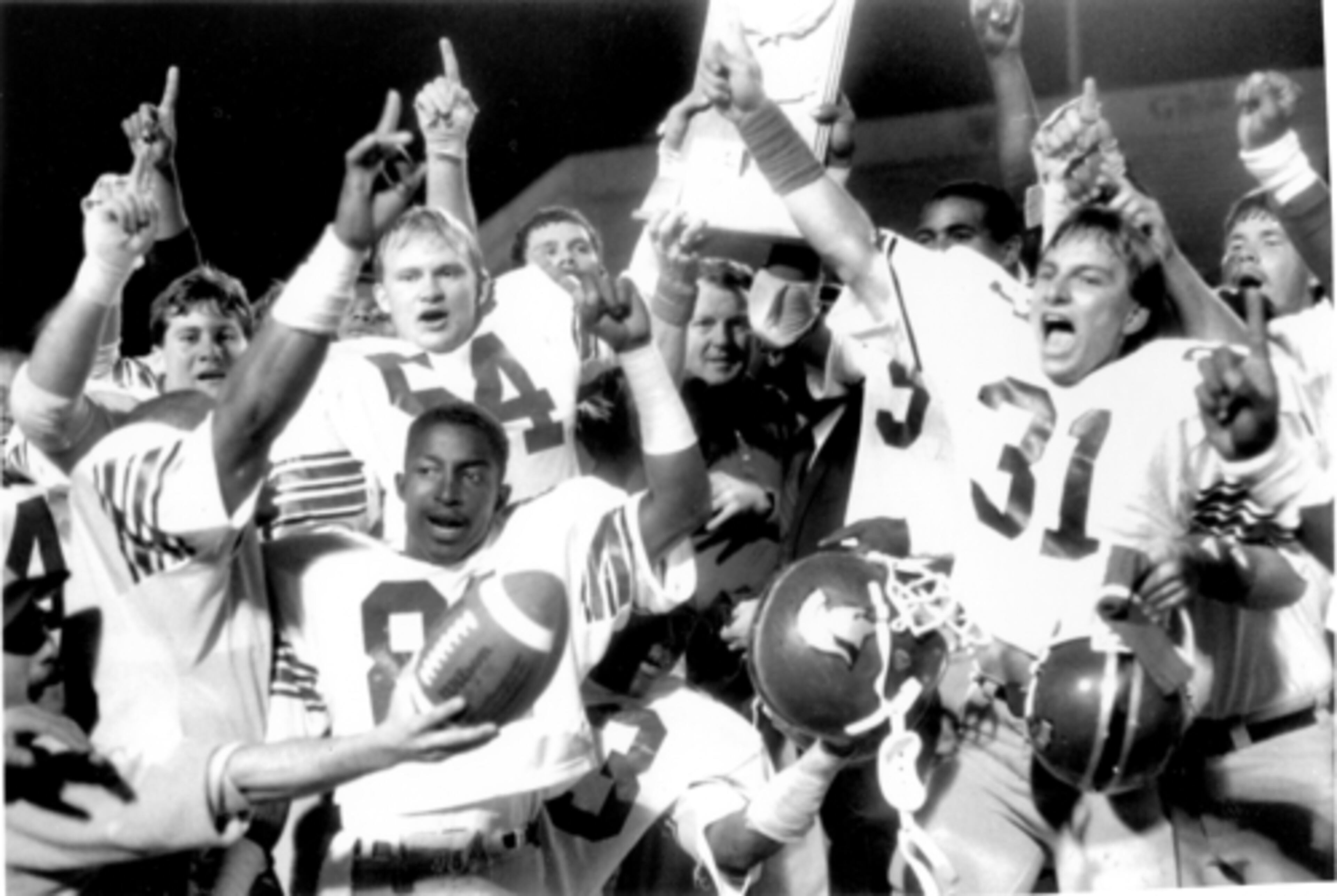 Gailey (in the middle) led Troy State to a 12-1 record and Division II national championship in 1984 before jumping to the pro ranks. He was an assistant coach with the Denver Broncos from 1985-90.