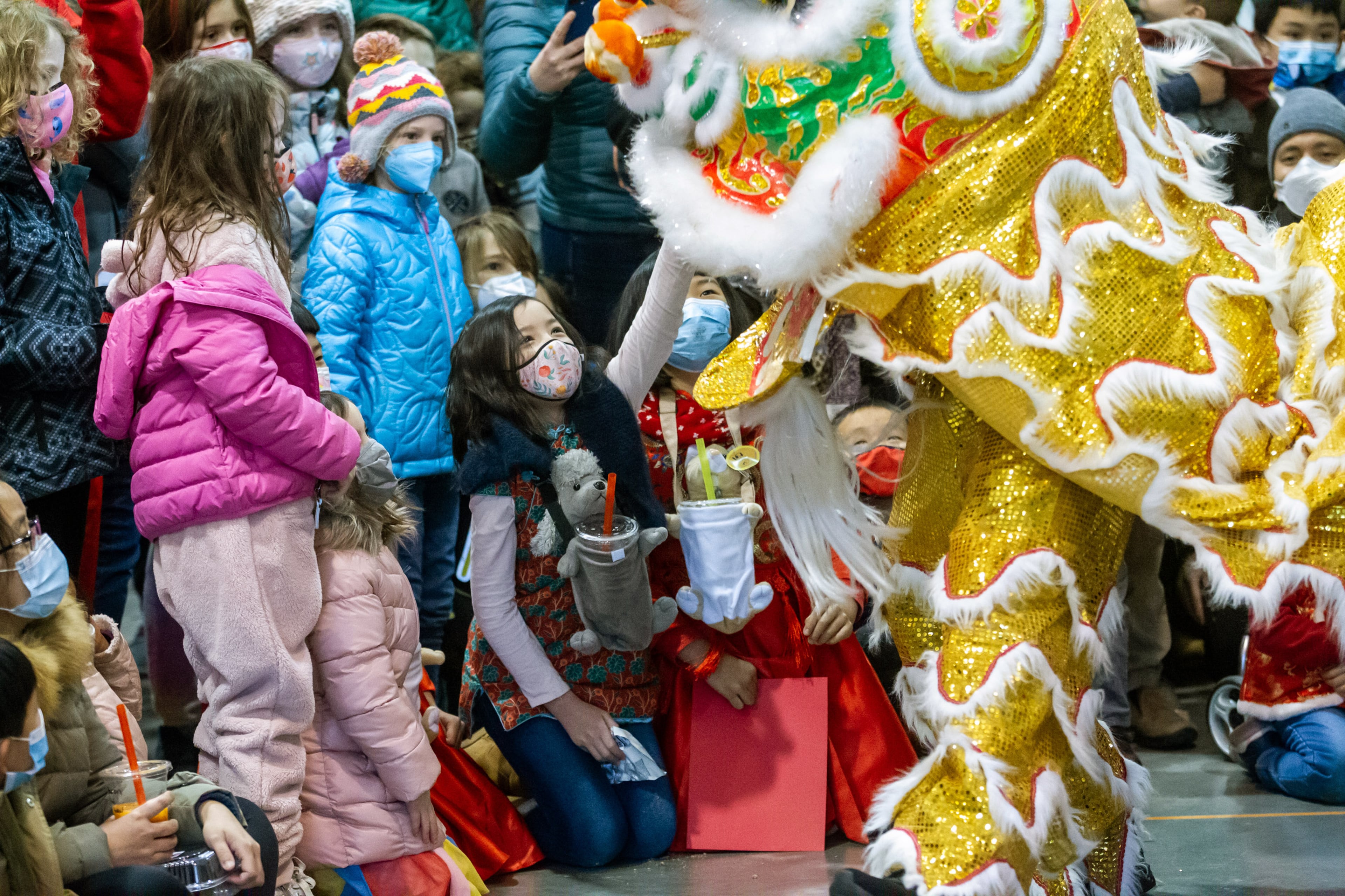 The audience responds as a performer walks near them during Decatur's first Lunar New Year celebration at Legacy Park on Saturday, January 29, 2022. STEVE SCHAEFER FOR THE ATLANTA JOURNAL-CONSTITUTION