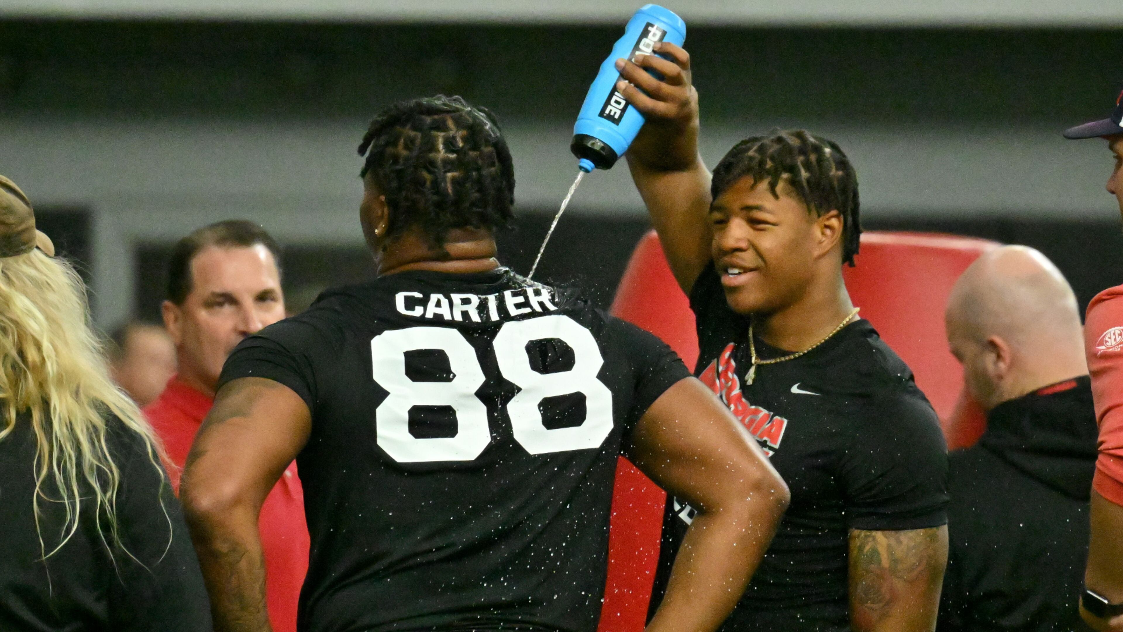 Georgia's linebacker Nolan Smith helps defensive lineman Jalen Carter cooling off during Georgia’s Pro Day in the Payne Indoor Athletic Facility, Wednesday, March 15, 2023, in Athens, GA. (Hyosub Shin / Hyosub.Shin@ajc.com)