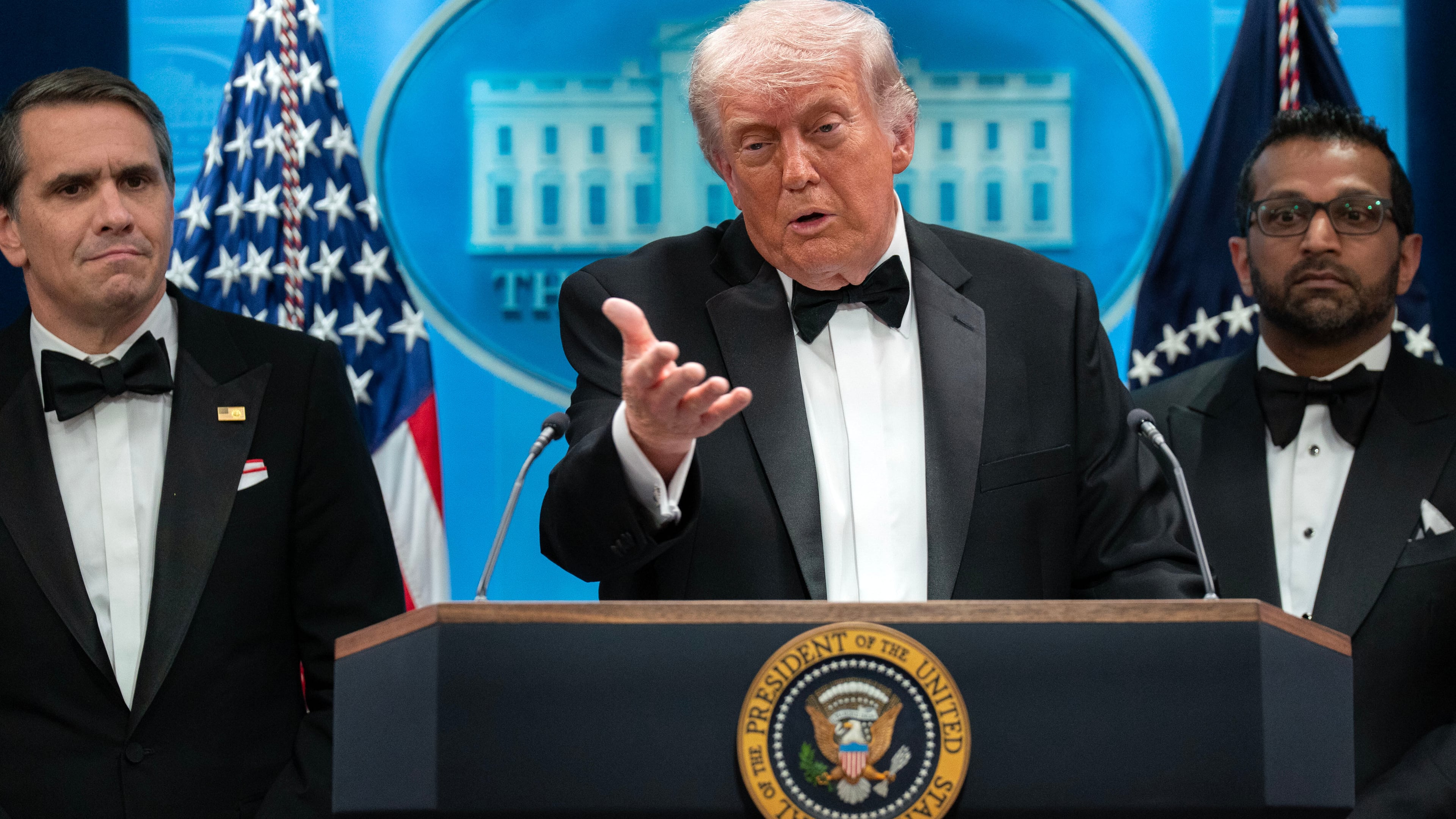 FILE - President Donald Trump speaks in the James Brady Press Briefing Room at the White House after a shooting incident outside the ballroom at at the annual White House Correspondents' Association dinner in Washington, April 25, 2026, as acting Attorney General Todd Blanche, left, and FBI director Kash Patel listen. (AP Photo/Jose Luis Magana, File)