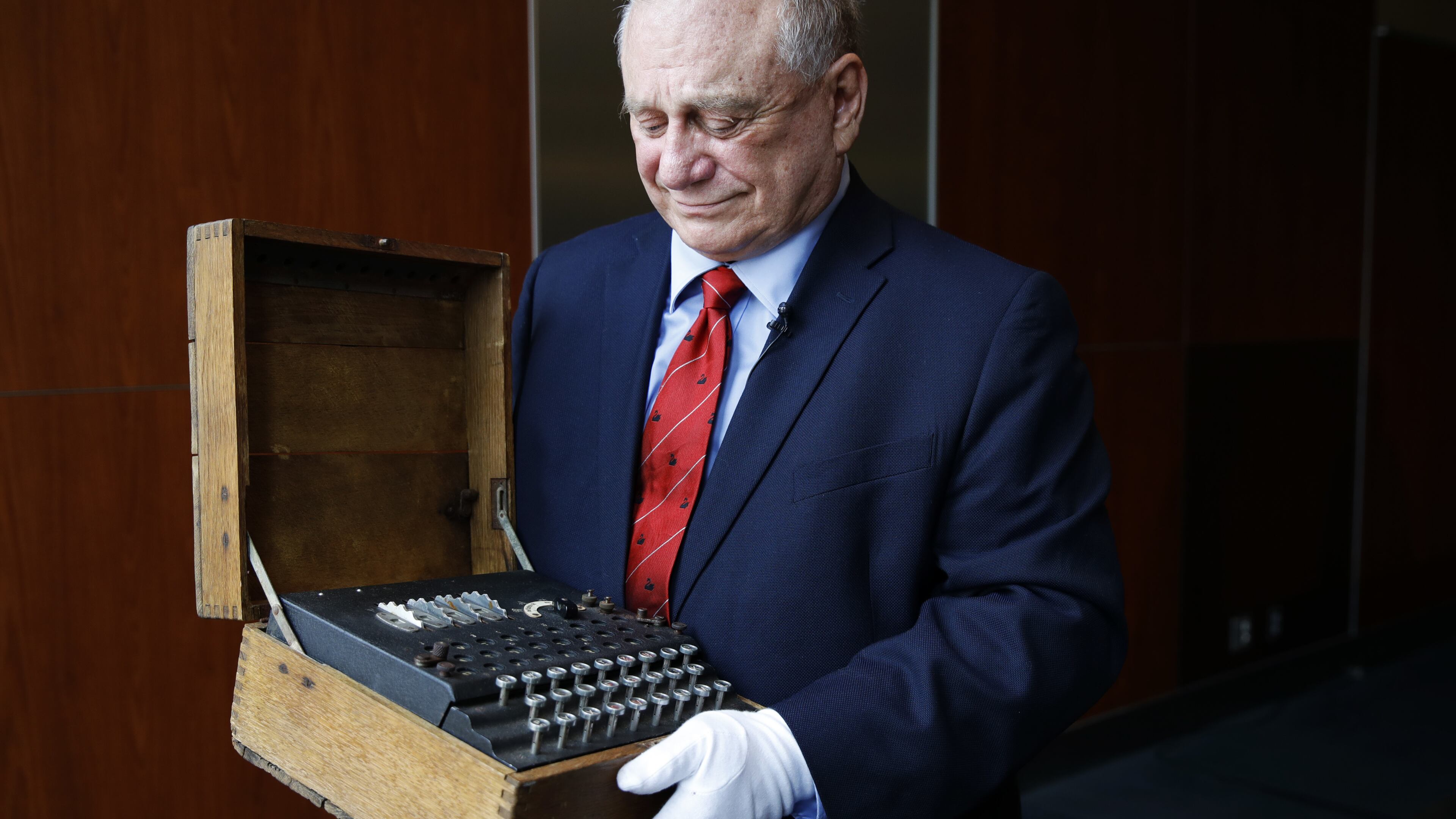 H. Keith Melton holds an Enigma Machine with four rotors and Japanese characters that was used in World War II to encode messages, Wednesday, Sept. 13, 2017, in Washington. The machine is one of the many items that he is donating to the International Spy Museum from his collection of spy objects. (AP Photo/Jacquelyn Martin)