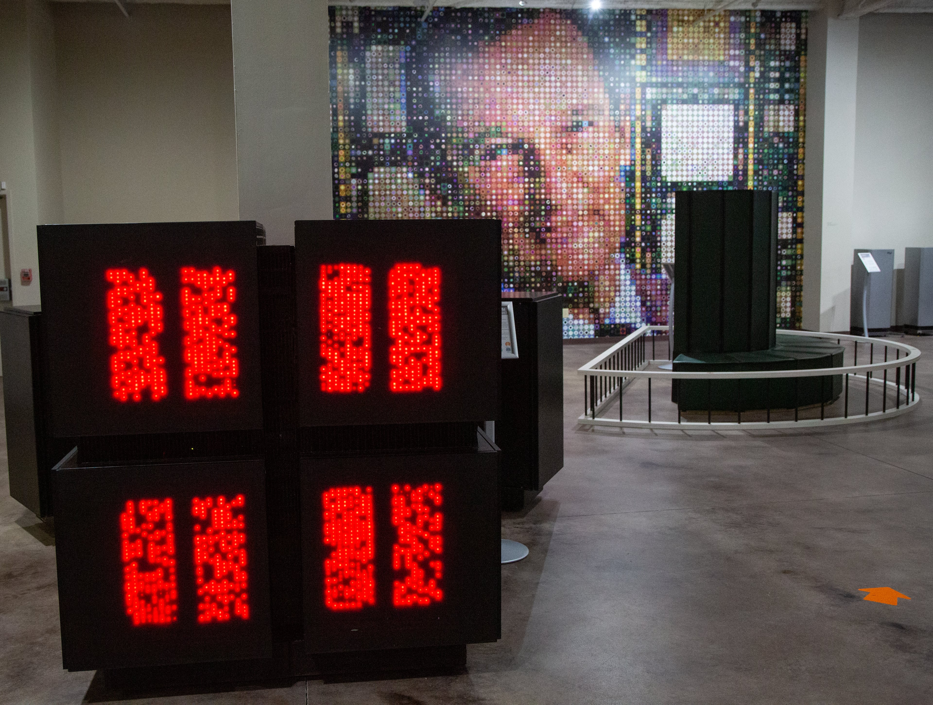 Lights dance across a 1987 Connection Machine CM2 with a mural of supercomputer architect Seymour Roger Cray behind it at the Computer Museum of America. PHIL SKINNER FOR THE ATLANTA JOURNAL-CONSTITUTION.