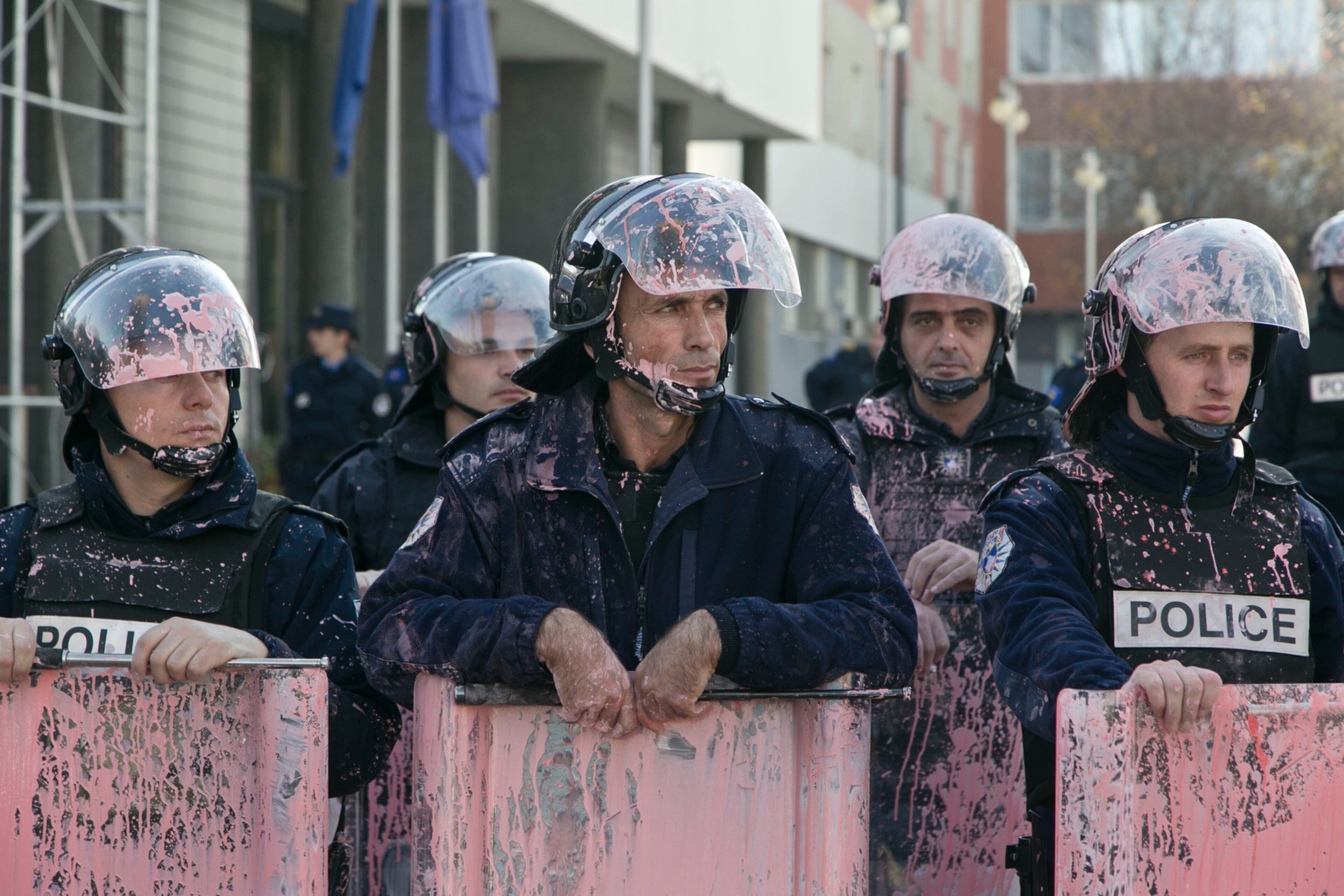 NOT QUITE THEIR COLOR--Kosovo police in riot gear are seen covered in pink paint after clashes outside Kosovo parliament building in the capital Pristina on Tuesday, Nov. 17, 2015. Kosovo opposition used tear gas and pepper spray inside parliament and pelted police with rocks and pink paint outside the building in another attempt to force the government to renounce recent deals with Serbia and Montenegro.(AP Photo/Visar Kryeziu)