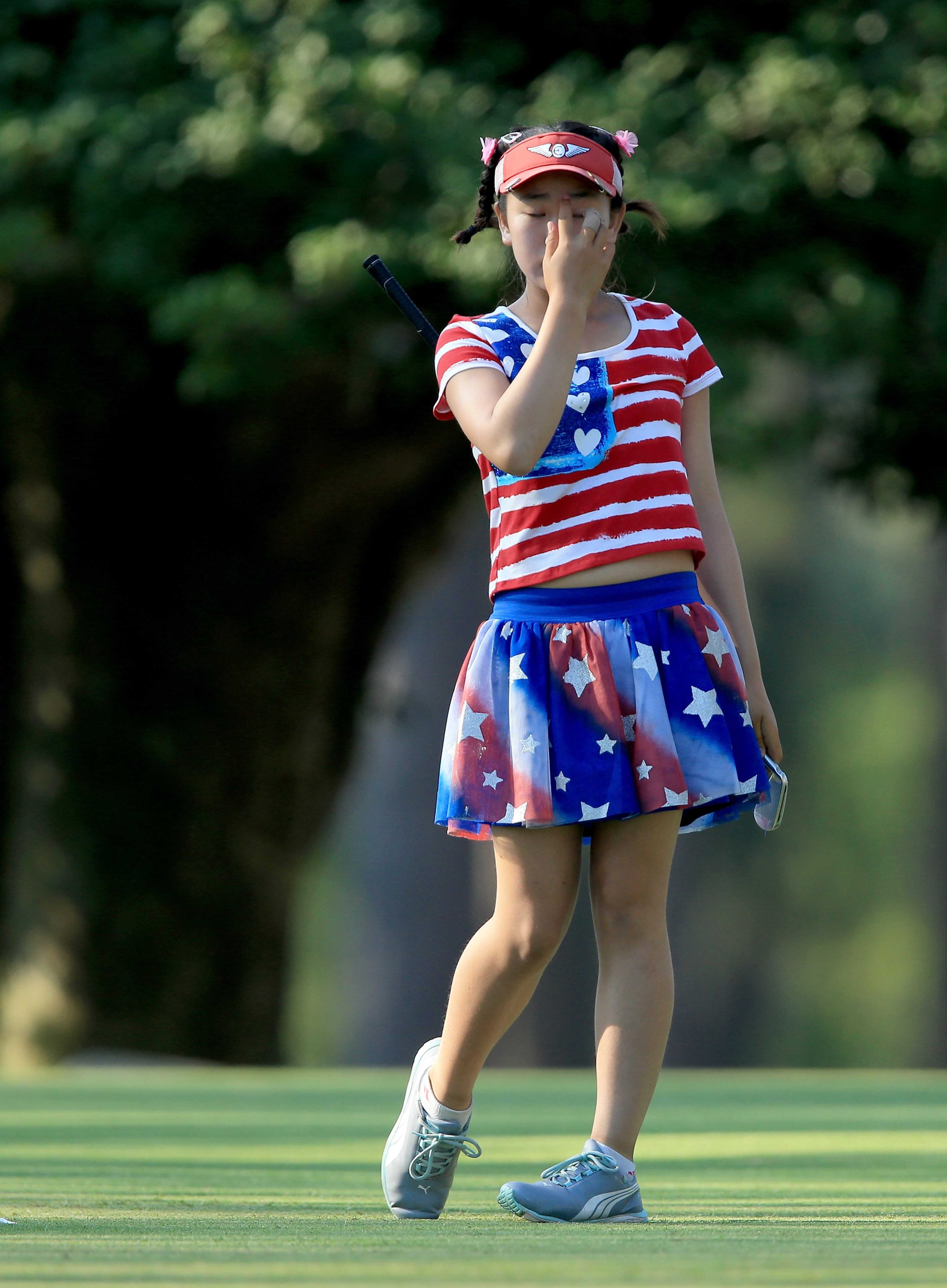 Lucy Li of the USA, who is only 11 years old, follows her tee shot at the par 3, 15th hole during the first round of the 69th U.S. Women's Open at Pinehurst Resort & Country Club, Course No. 2 on June 19, 2014 in Pinehurst, North Carolina. (Photo by David Cannon/Getty Images)