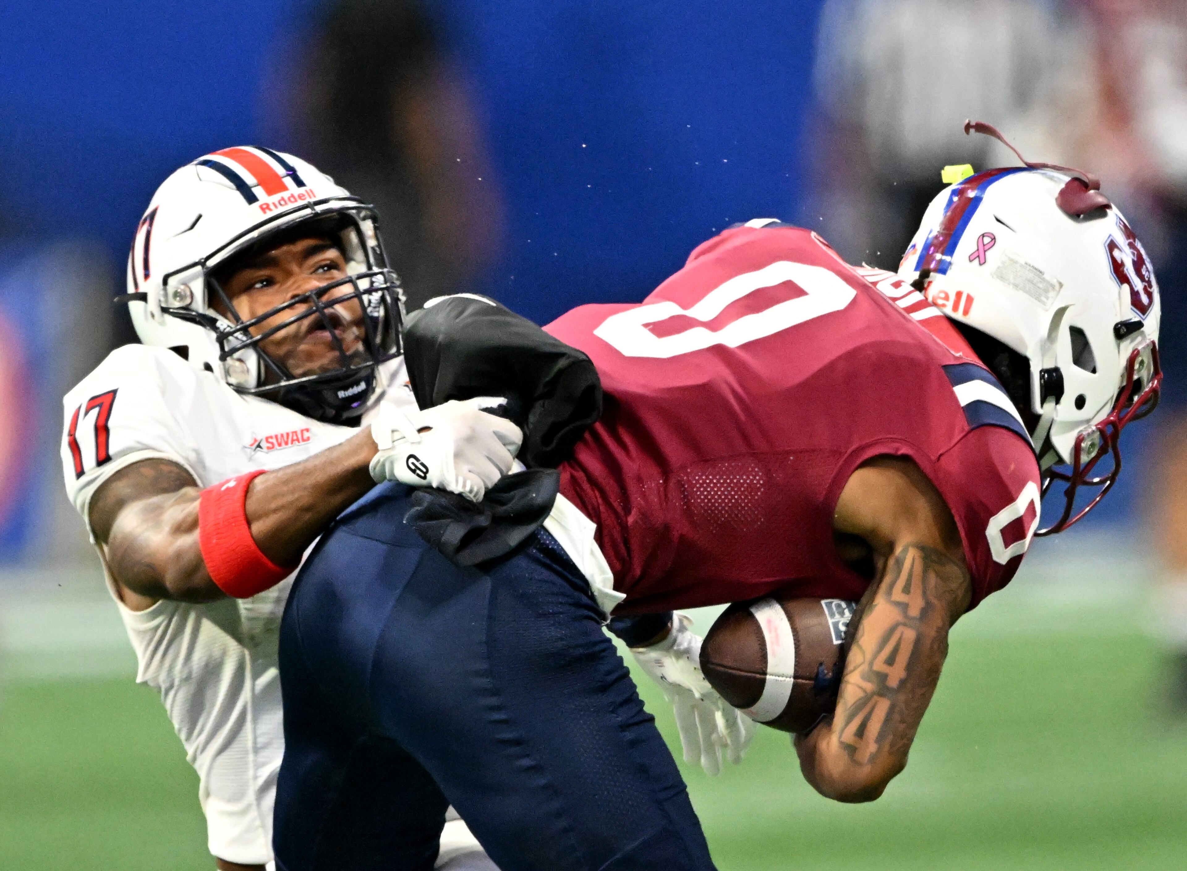 South Carolina State wide receiver Caden High (0) gets tackled by Jackson State defensive back KJ Chisholm (17) during the first half in 2024 Cricket Celebration Bowl at Mercedes-Benz Stadium, Saturday, December 14, 2024, in Atlanta. (Hyosub Shin / AJC)