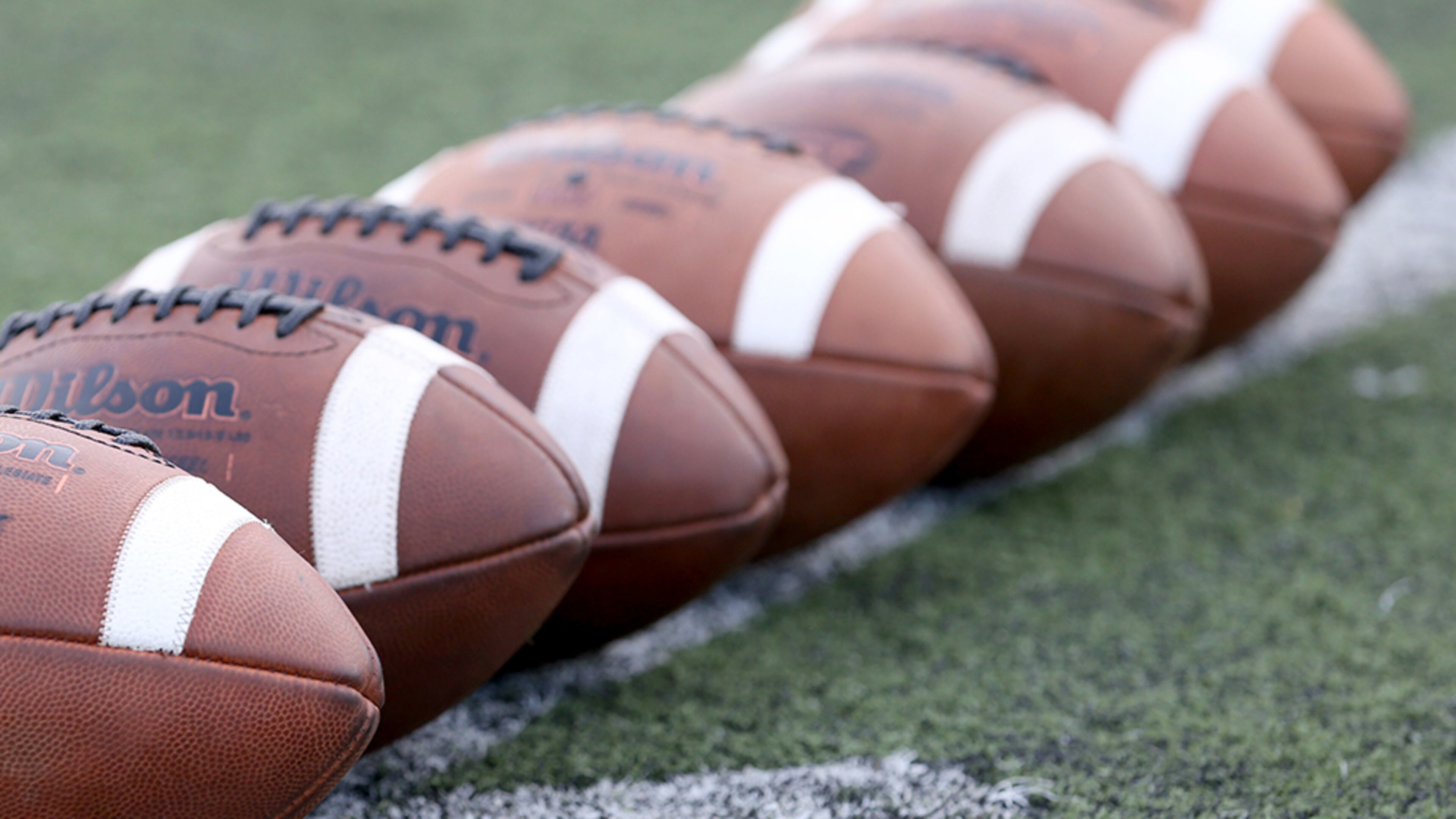 August 21, 2015 - Roswell, Ga: Footballs are placed at midfield before the game between Roswell and Lowndes Friday at Roswell High School in Roswell, Ga., AAugust 21, 2015. Tonight is the first game of the season for both Roswell and Lowndes. PHOTO / JASON GETZ