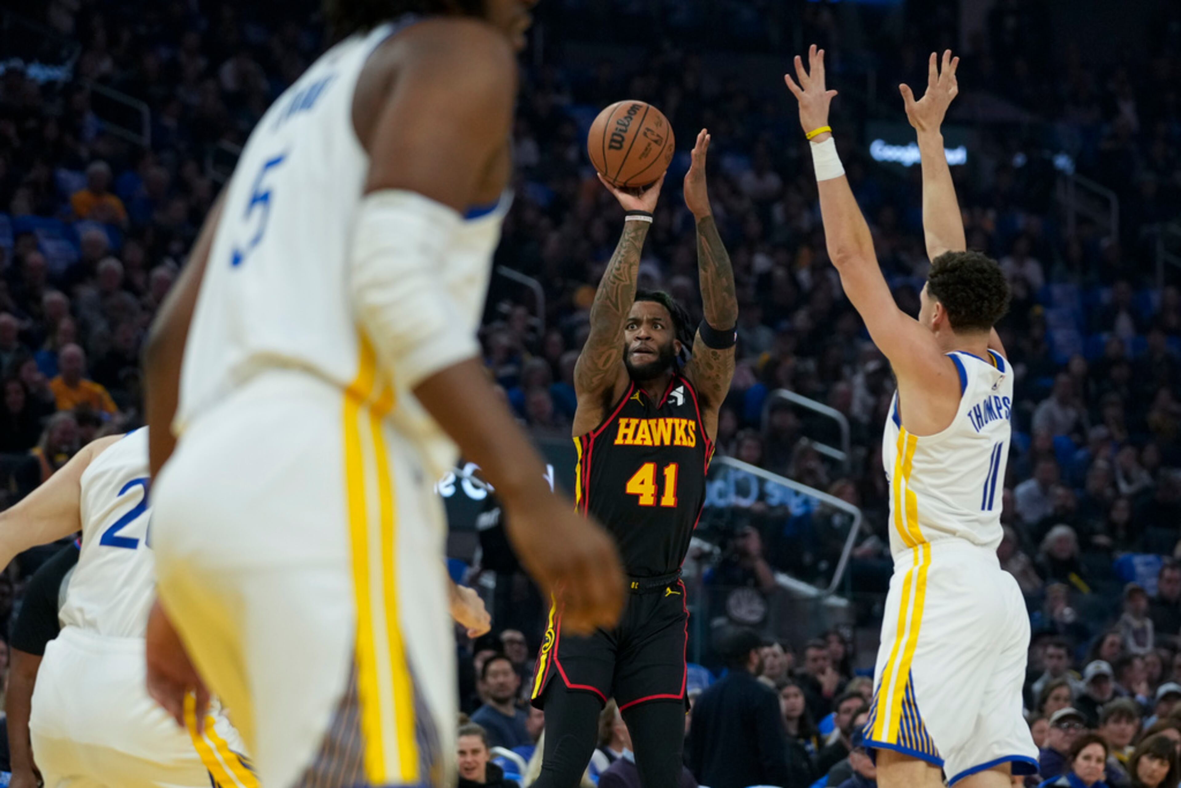 Atlanta Hawks forward Saddiq Bey (41) shoots next to Golden State Warriors guard Klay Thompson, right, during the first half of an NBA basketball game, Wednesday, Jan. 24, 2024, in San Francisco. (AP Photo/Godofredo A. Vásquez)