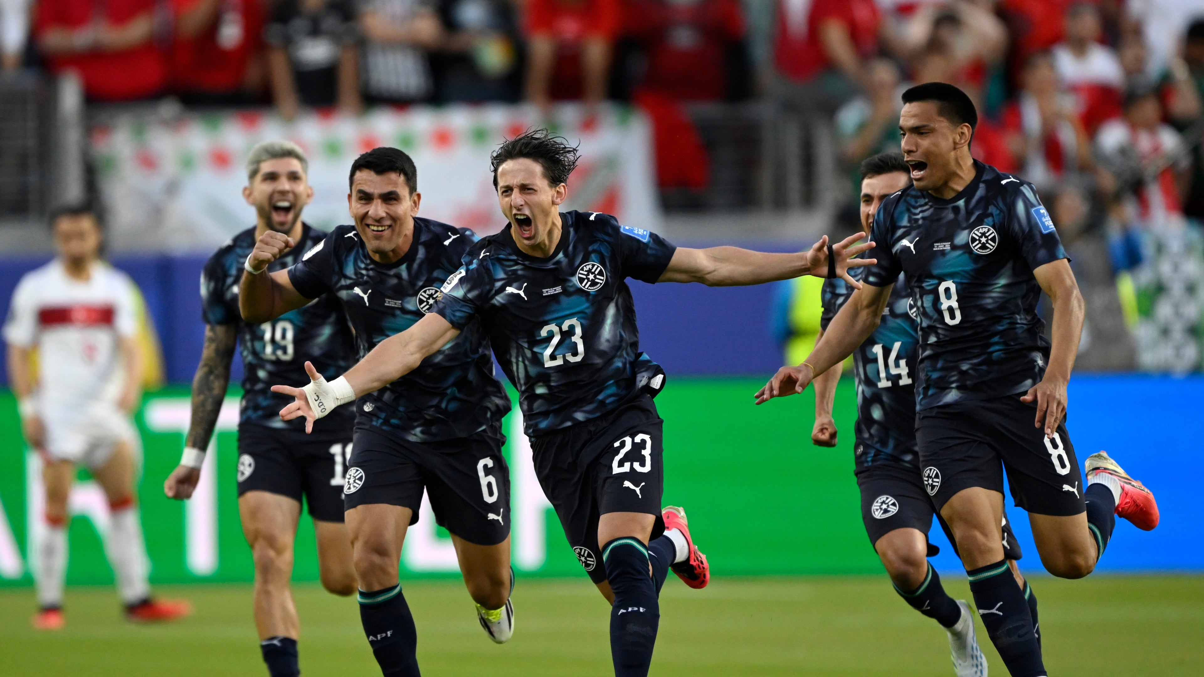 Paraguay's Matias Galarza (23) celebrates with Junior Alonso (6) and Diego Gomez (8) after scoring their opening goal during the World Cup Group D soccer match between Turkey and Paraguay in Santa Clara, Calif., near San Francisco, Friday, June 19, 2026. (AP Photo/Eakin Howard)