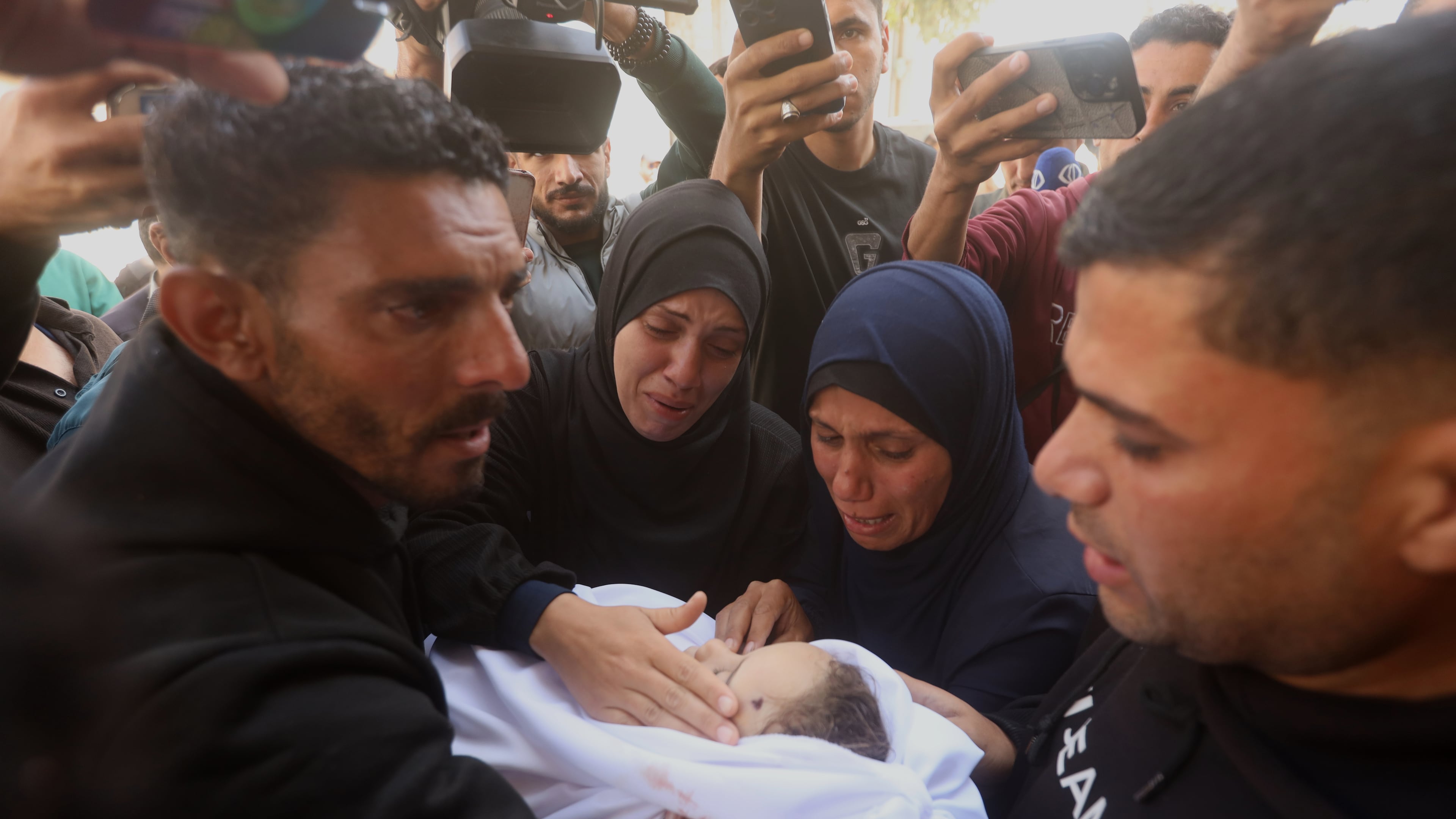 Palestinians mourn over an Al-Tanani family member, killed in an Israeli strike, during their funeral at Al-Shifa Hospital in Gaza City, Saturday, April 25, 2026. (AP Photo/Yousef Alzanoun)