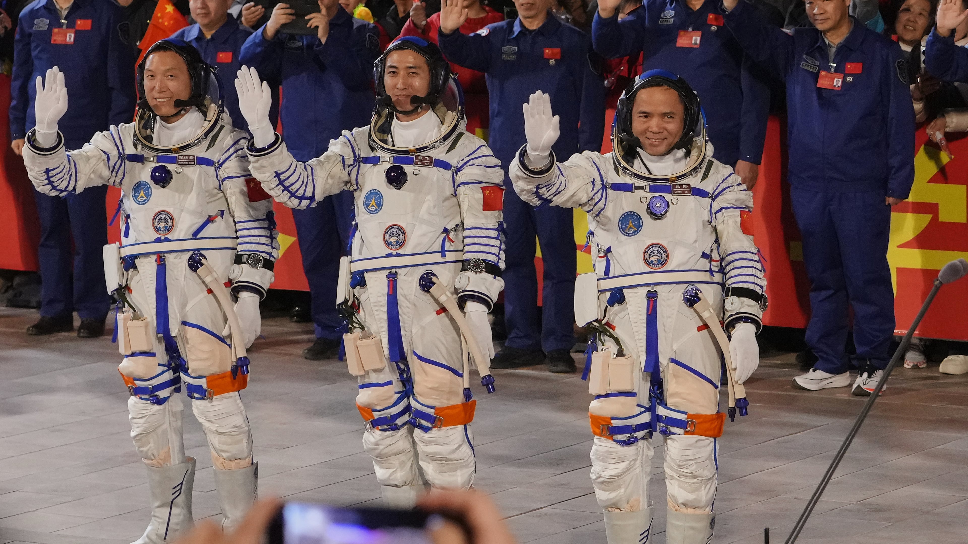 FILE - Chinese astronaut for the Shenzhou 21 mission, from left, Zhang Hongzhang, Wu Fei and Zhang Lu wave as they attend a see-off ceremony for their manned space mission at the Jiuquan Satellite Launch Center in northwestern China, Friday, Oct. 31, 2025. (AP Photo/Andy Wong, File)