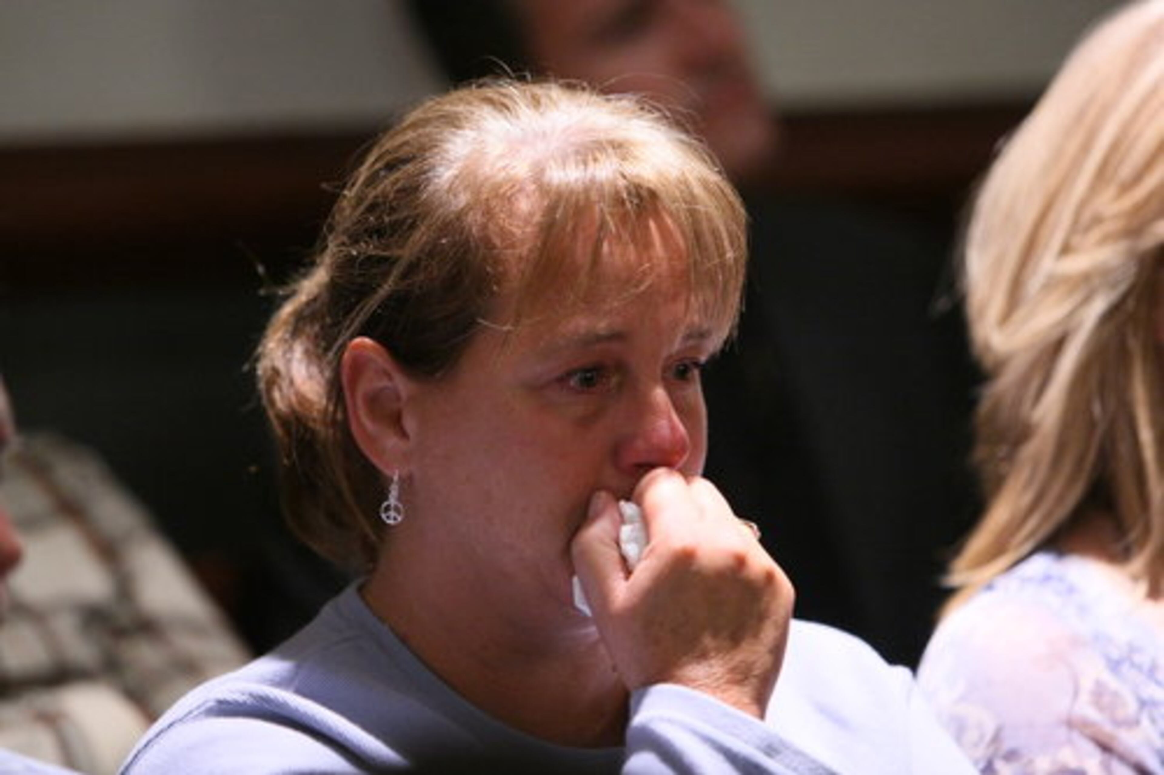 Holly Ditmar, a daughter of Judge Rowland Barnes, who was killed in his Fulton County courtroom, tears up at the end of Clint Rucker's closing arguments on Monday,