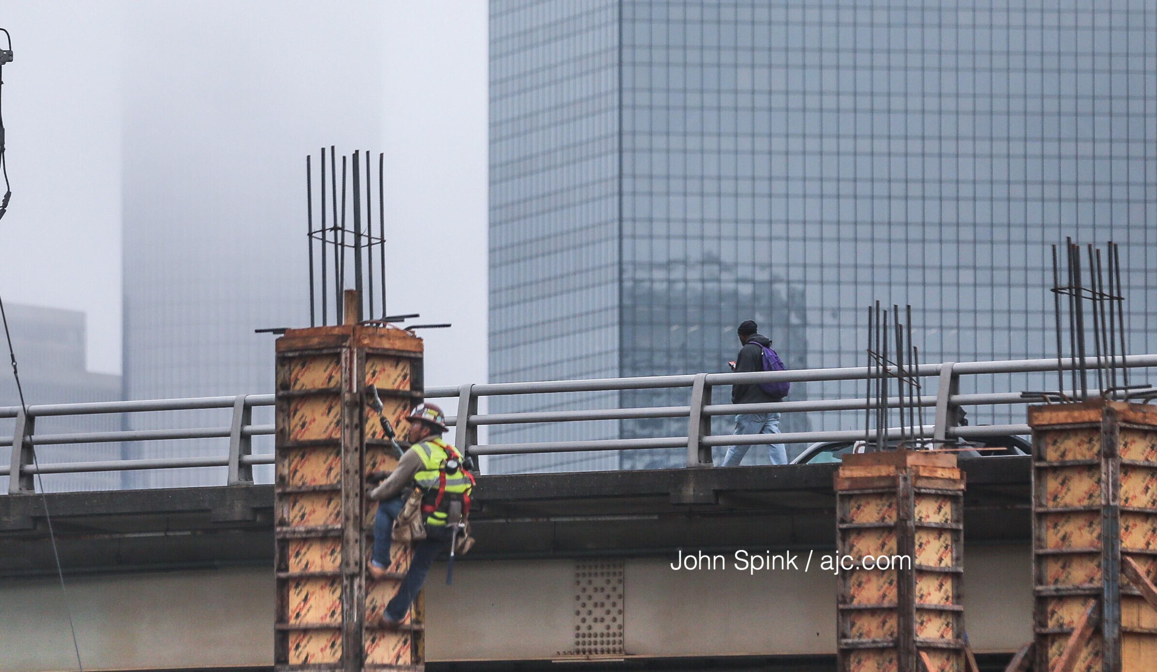 Against a foggy skyline at Mitchell and Magnum streets, construction crews work on Castleberry Park, a mixed-use development on Atlanta's Westside. JOHN SPINK / JSPINK@AJC.COM