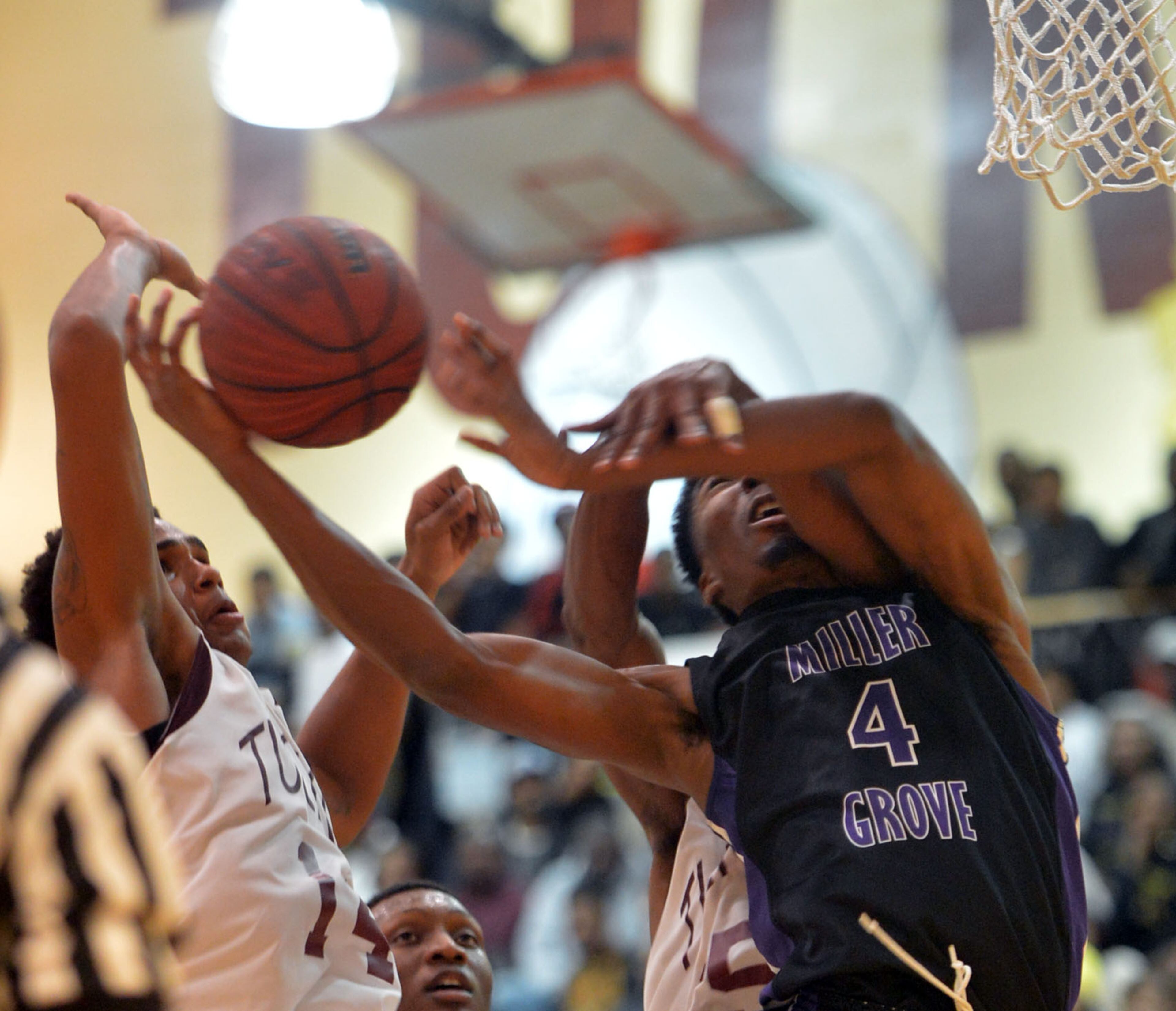Miller Grove's Raylon Richardson is fouled by Tucker's Tyrell Thomas during action in the second half of the Miller Grove at Tucker HS boys basketball game at Tucker HS on Friday, Jan. 17, 2014. Miller Grove's boys team has won five consecutive championships in the state's second-highest classification. And the Wolverines, led by Tulane signee Keith Pinckney, are ranked No. 1 again this season.