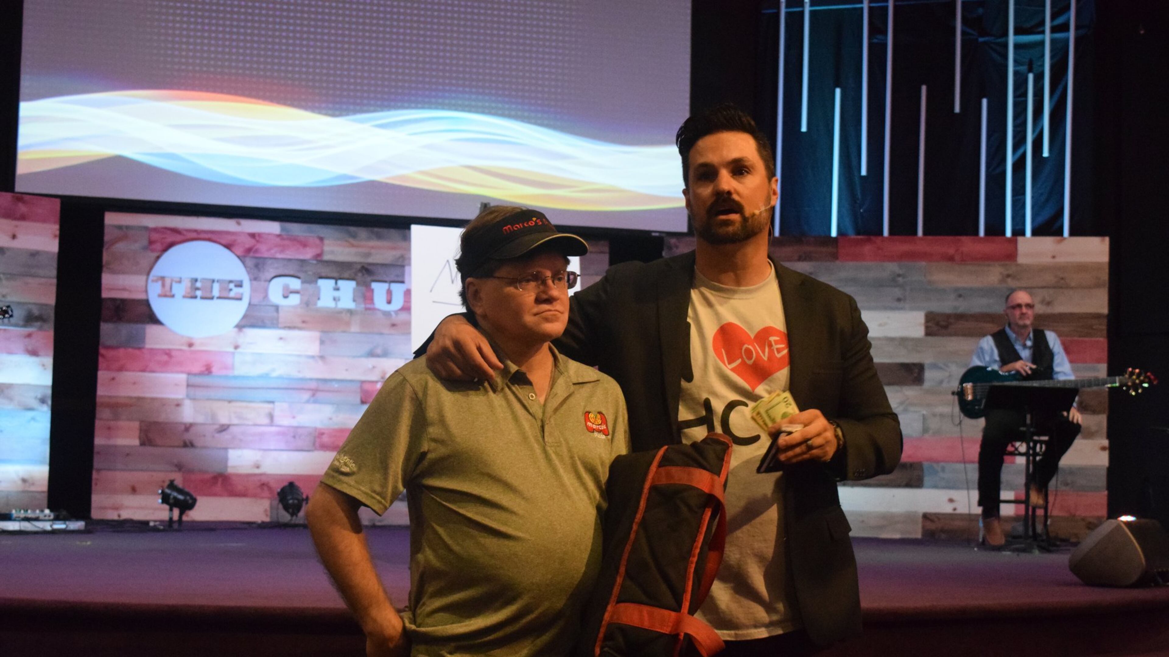 Curtus Moak (right), lead pastor at Hamilton Christian Center, surprised pizza delivery driver Kenny Sharp (left) on Sunday with a tip in the amount of $3,000. CONTRIBUTED
