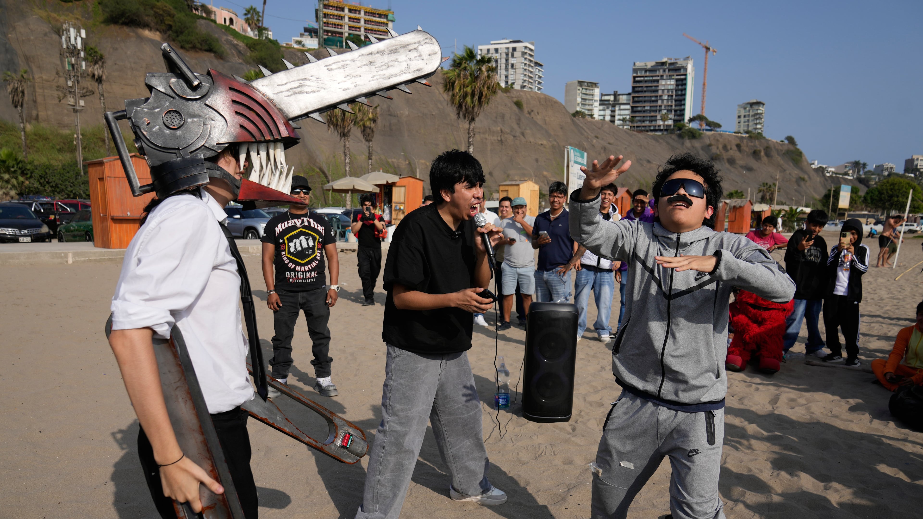 Young men dressed as “Mr. Chainsaw” and “Maduro” face off in an aura-farming battle at Las Sombrillas beach in Lima, Peru, Saturday, Aug. 29, 2026. (AP Photo/Martin Mejia)