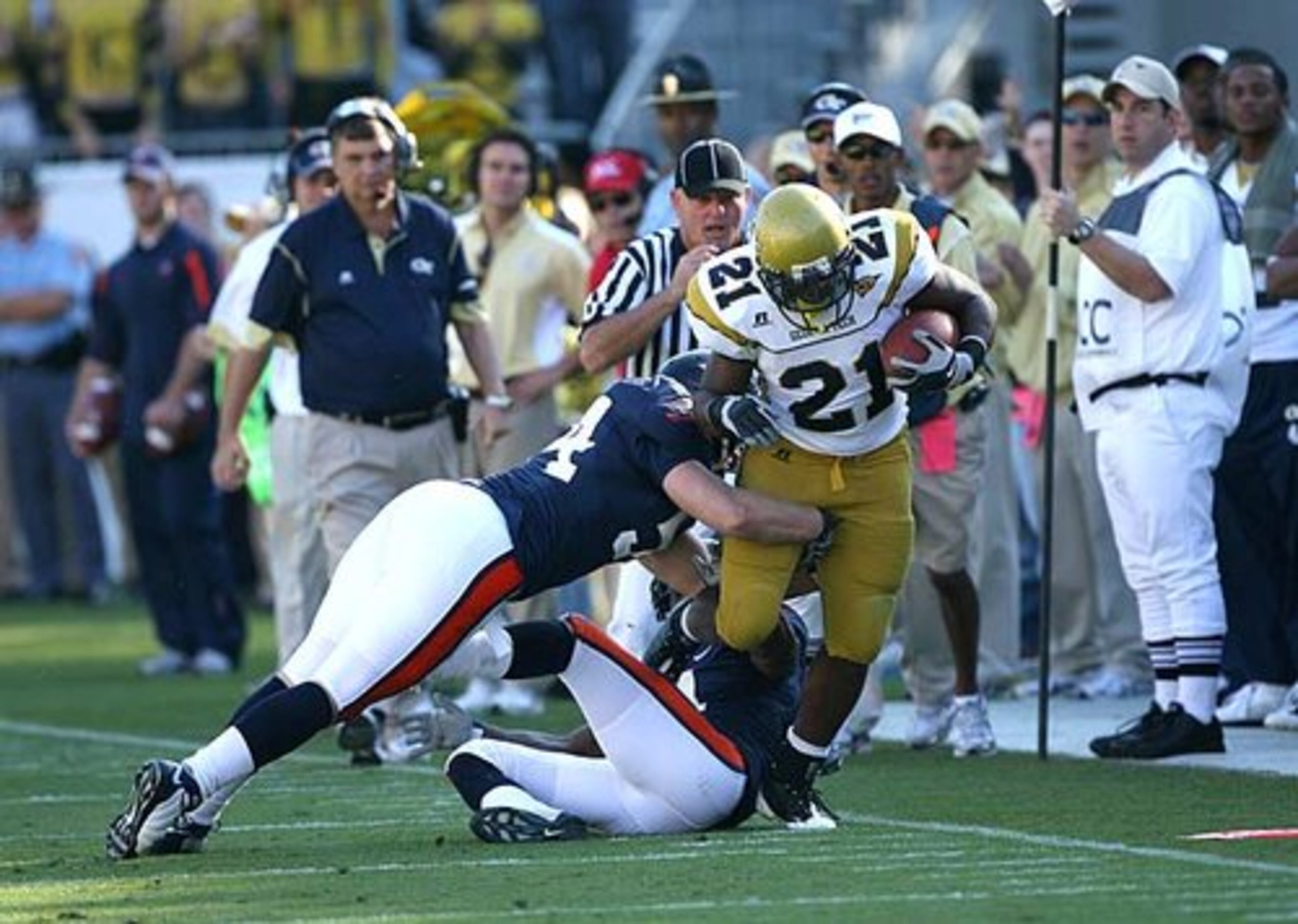 Georgia Tech's Jonathan Dwyer fights for extra yards as he is tackled by Virginia's Jon Cooper (54) and Vic Hall (4) in the scond quarter.