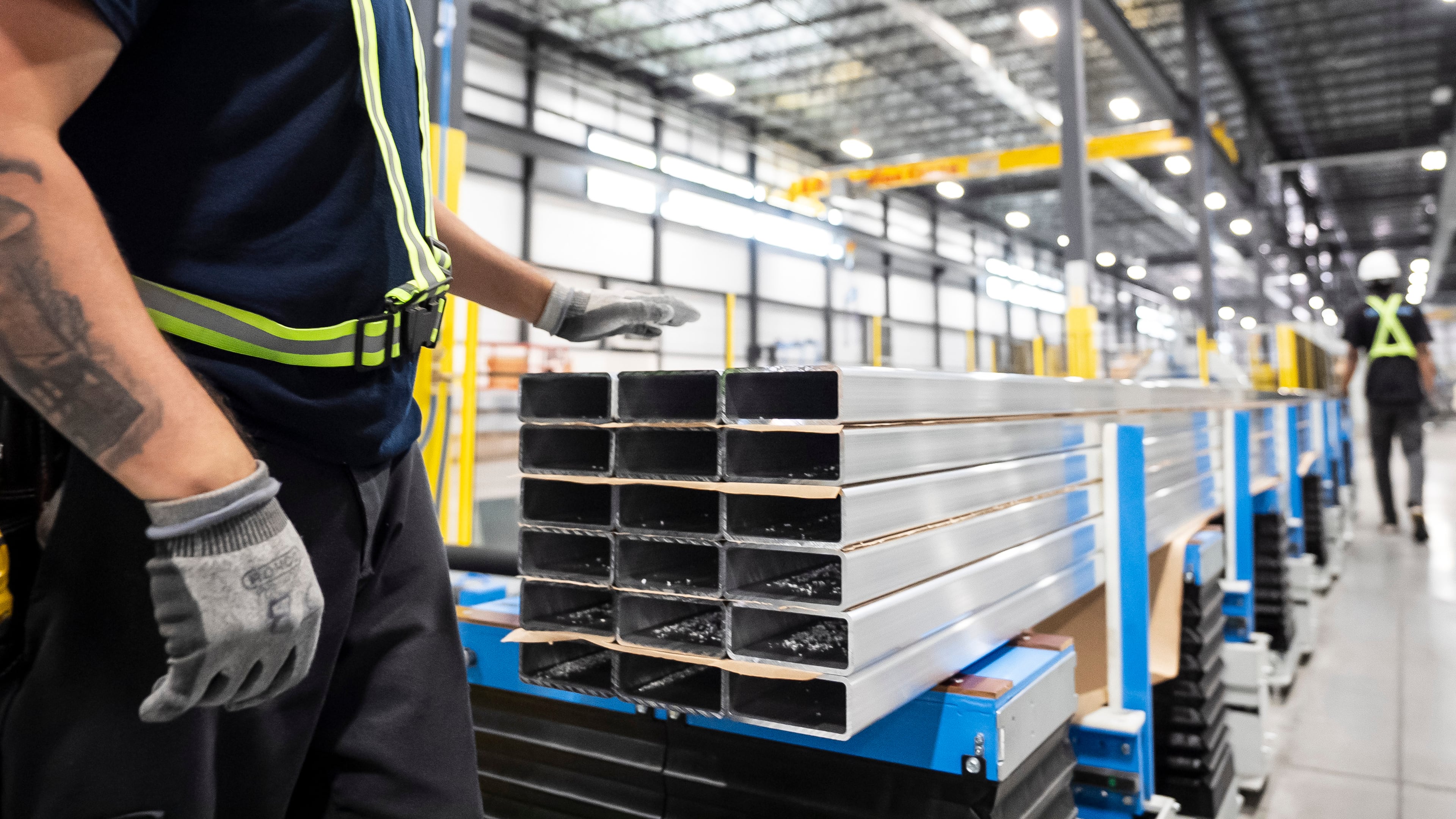 FILE - Workers prepare extruded aluminum product for packaging at Magna Aluminum Profile's fully electric powered extrusion facility in Salaberry-de-Valleyfield, Quebec, Canada, on Sept. 3, 2025. (Christopher Katsarov/The Canadian Press via AP, File)