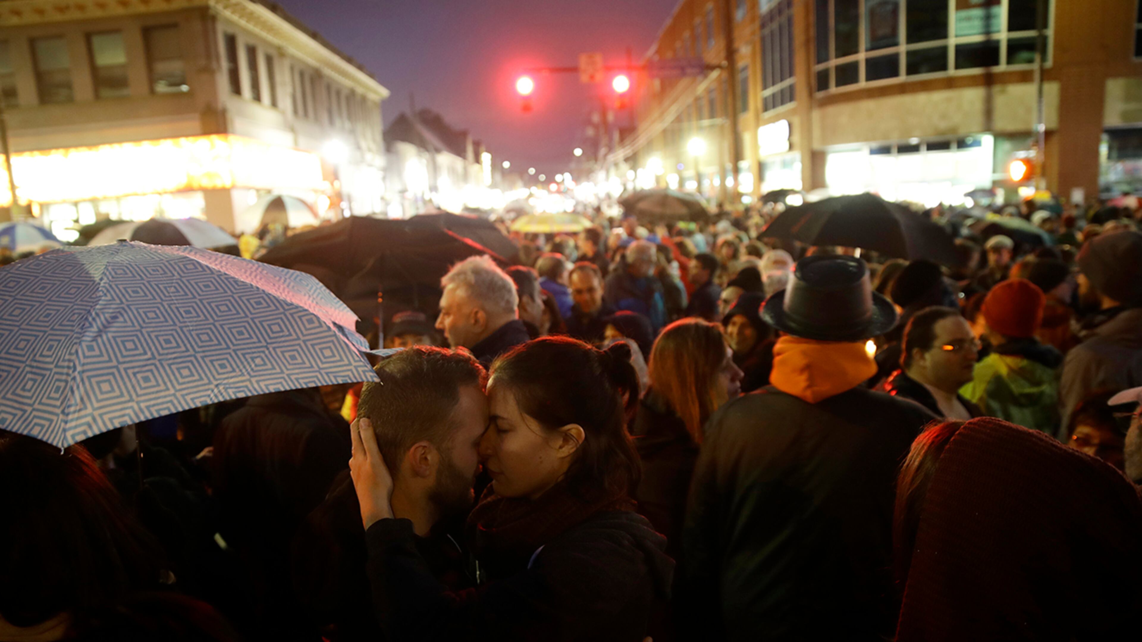 Curt Conrad and Rachel Simmons embrace after a vigil held in the aftermath of a deadly shooting at the Tree of Life Synagogue, in the Squirrel Hill neighborhood of Pittsburgh, Saturday, Oct. 27, 2018. (AP Photo/Matt Rourke)