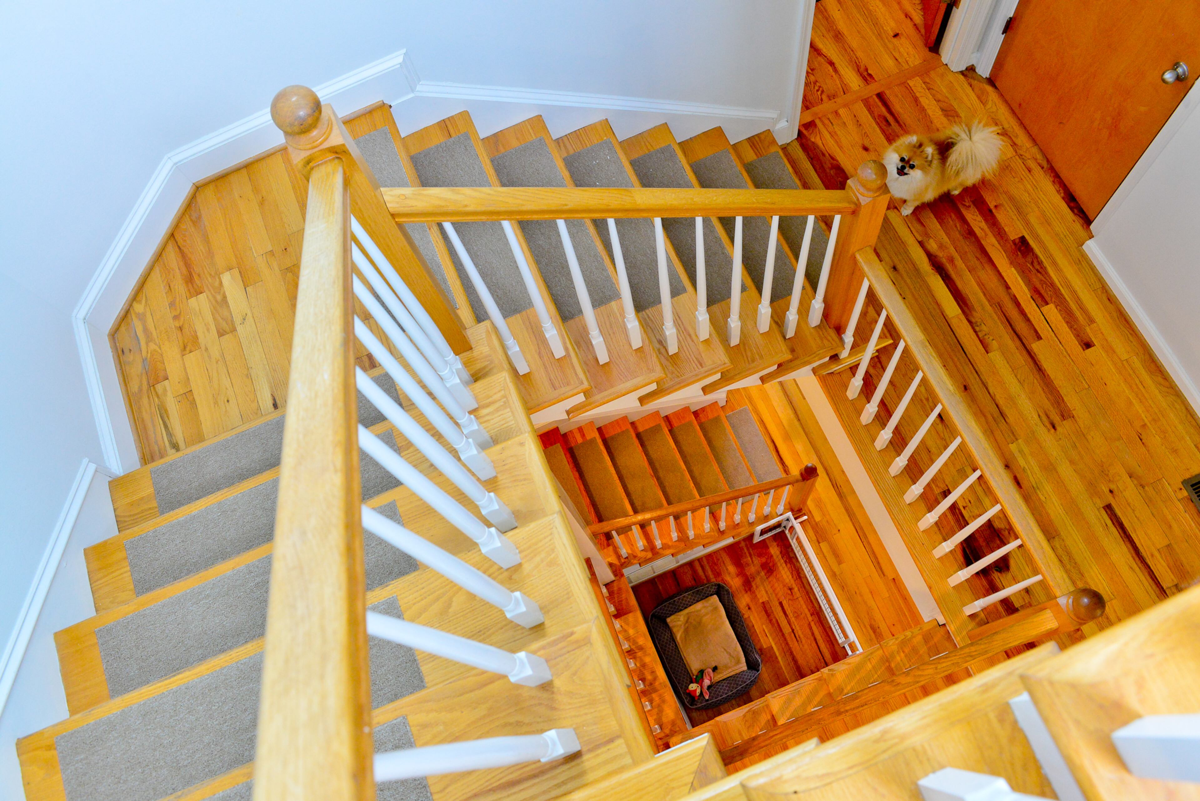 The interior is divided into three floors, with a twisting staircase at the center. The square center complements the clean, modern design in the rest of the home.