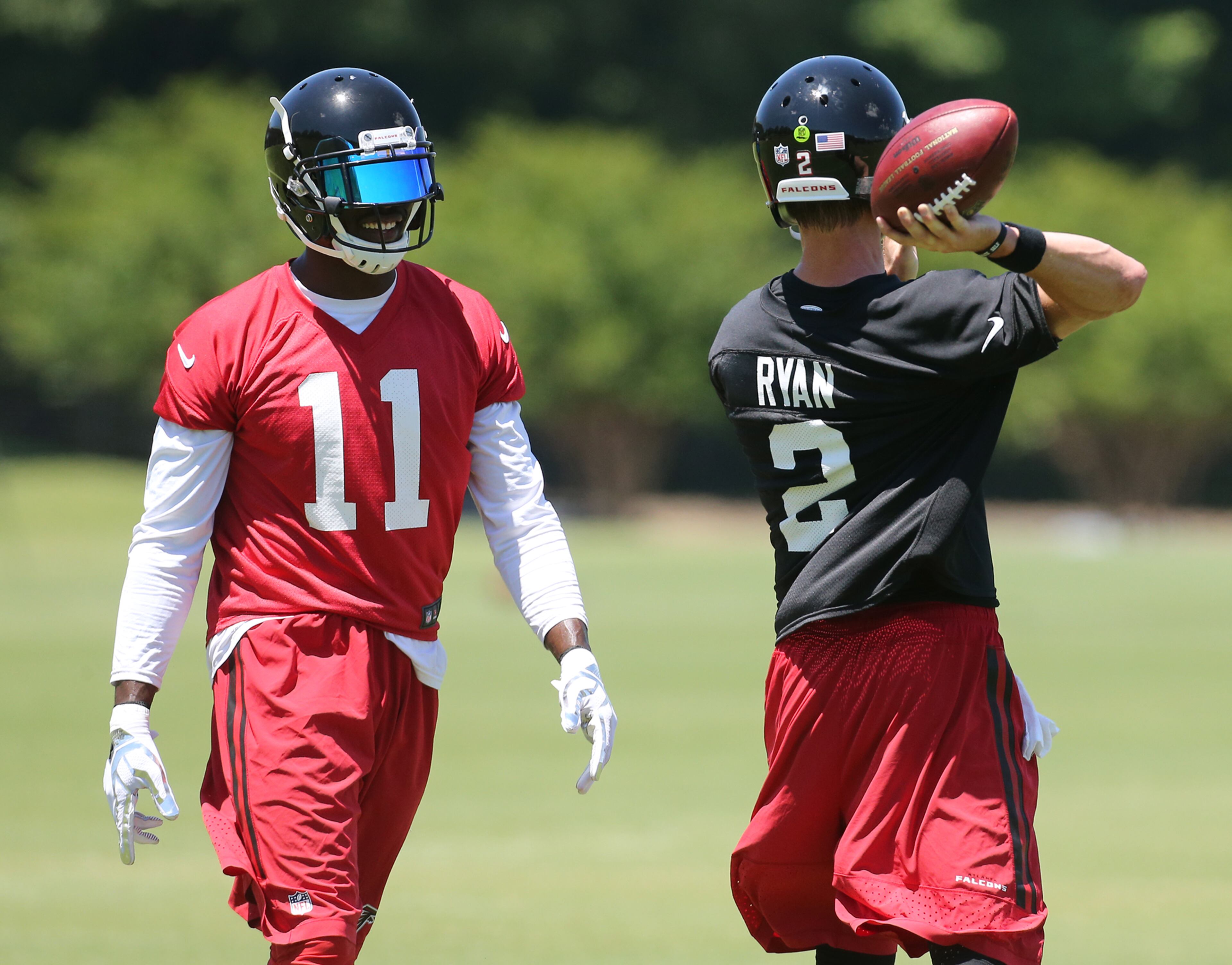 Falcons wide receiver Julio Jones looks on as Matt Ryan throws a pass during team practice on an OTA day, Tuesday, June 7, 2016, in Flowery Branch. Curtis Compton / ccompton@ajc.com