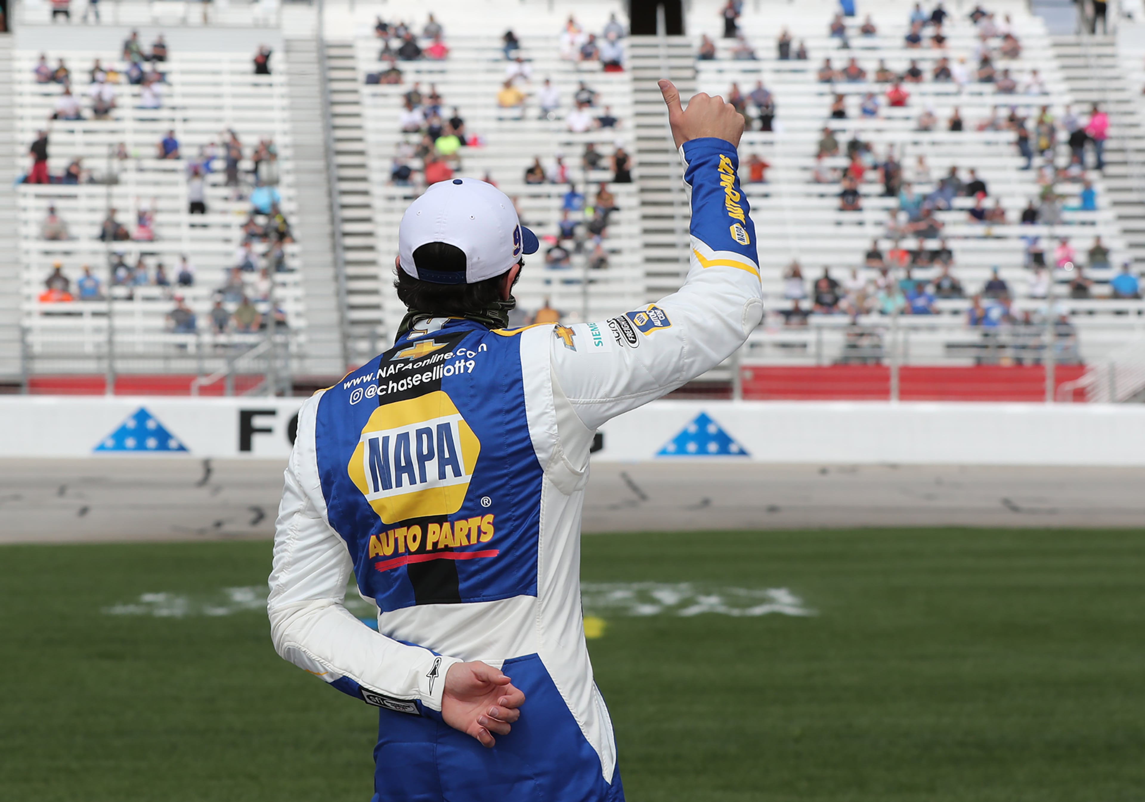 Chase Elliott - of Dawsonville - gives socially distanced fans a thumbs up just before the start of the Folds of Honor QuikTrip 500 Sunday, March 21, 2021, at Atlanta Motor Speedway in Hampton. (Curtis Compton / Curtis.Compton@ajc.com)