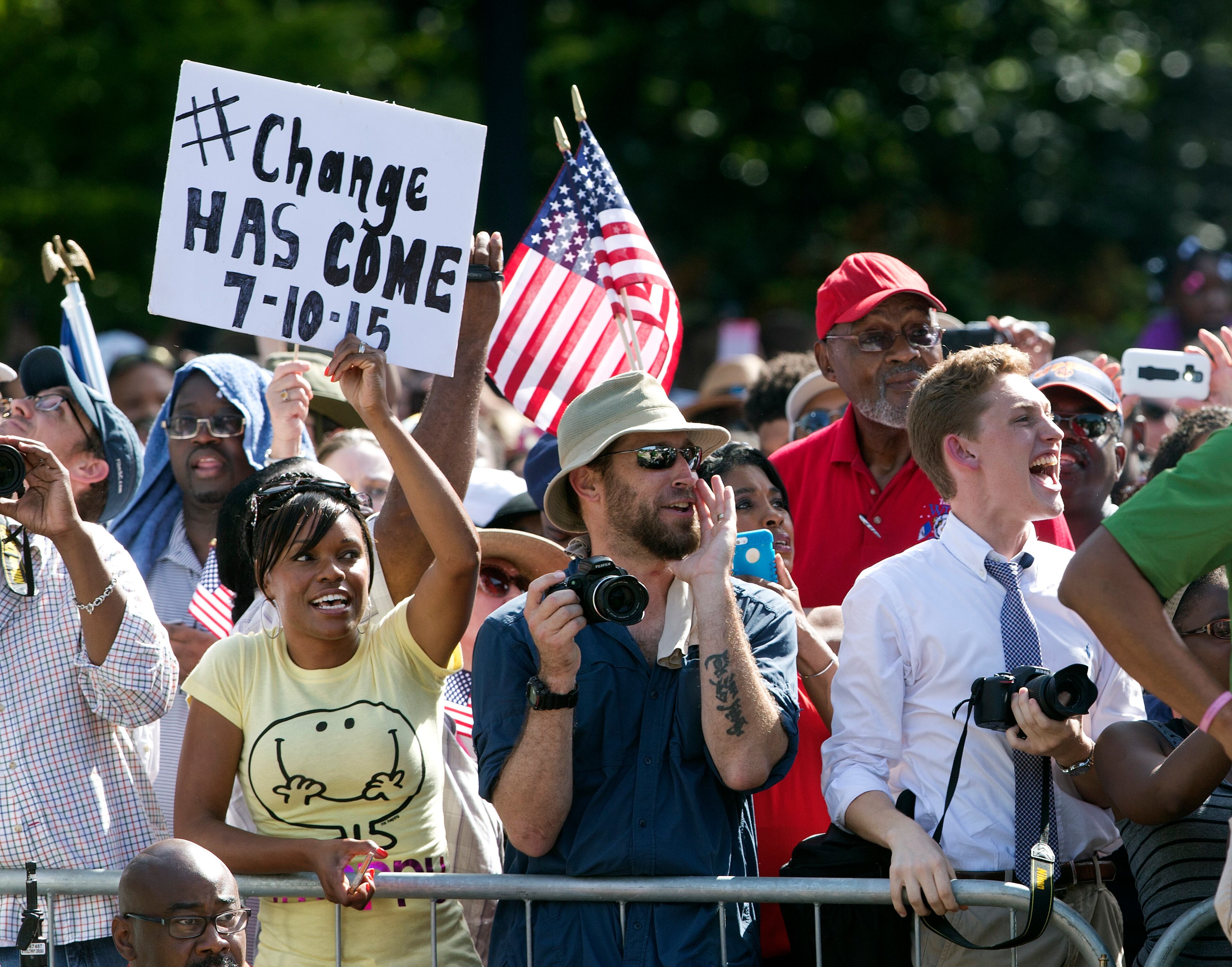 People cheer as an honor guard from the South Carolina Highway patrol removes the Confederate battle flag from the Capitol grounds Friday, July 10, 2015, in Columbia, S.C. The Confederate flag was lowered from the grounds of the South Carolina Statehouse to the cheers of thousands on Friday, ending its 54-year presence there and marking a stunning political reversal in a state where many thought the rebel banner would fly indefinitely. (AP Photo/John Bazemore)