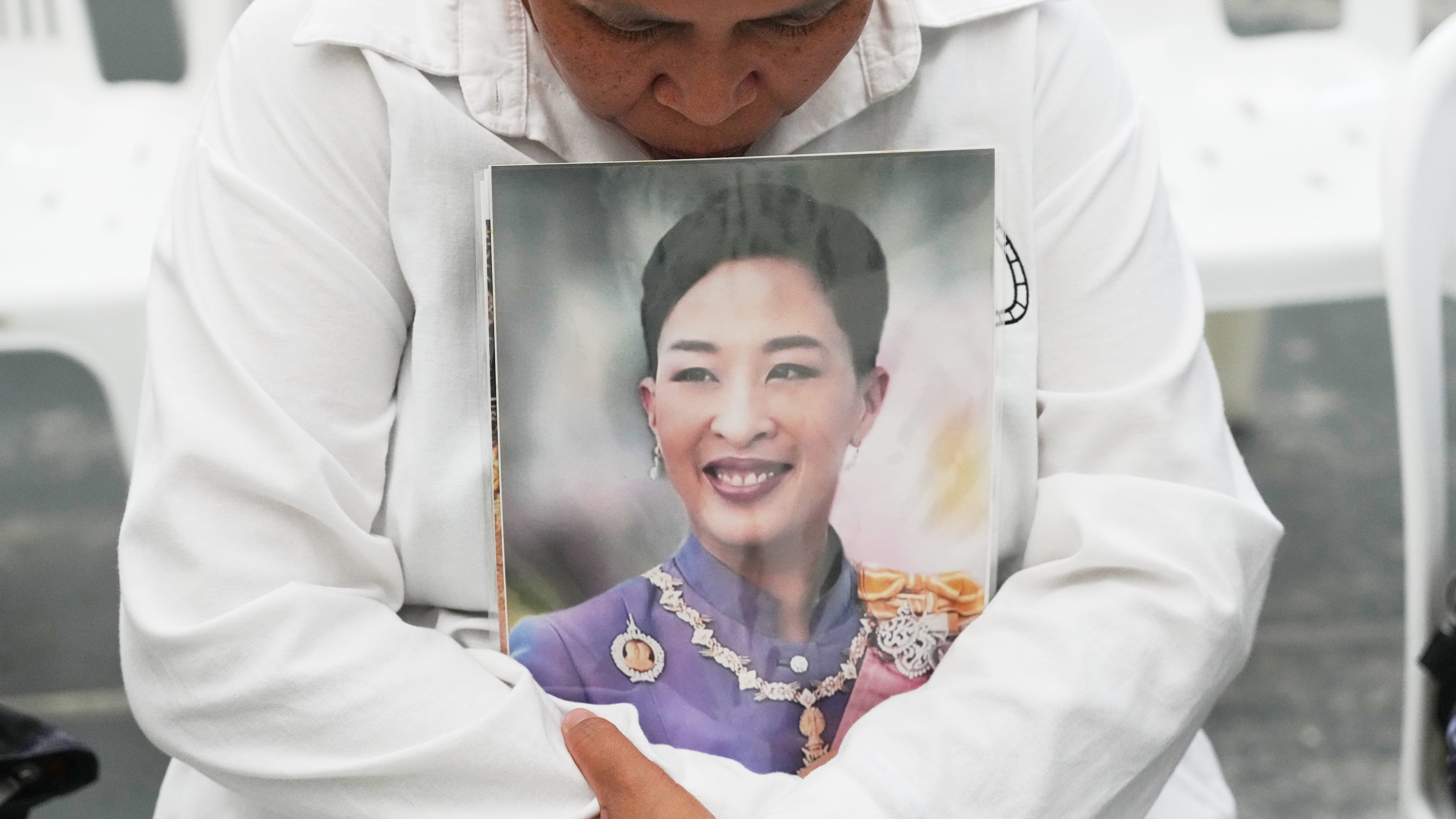 A person holds a picture of the late Thailand Princess Bajrakitiyabha Mahidol in Bangkok, Thailand, Friday, June 12, 2026. (AP Photo/Sakchai Lalit)
