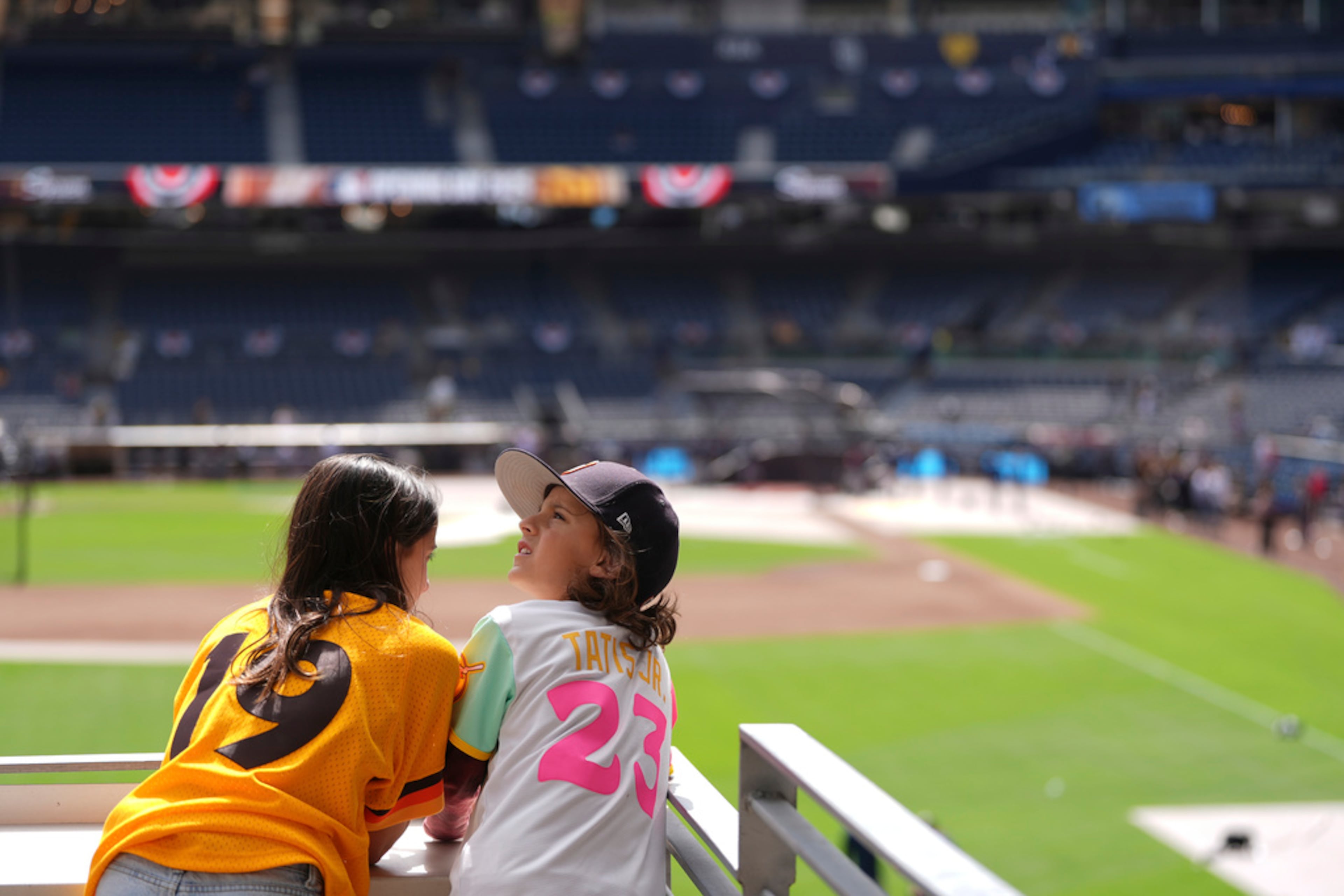Cruz, right, and Camryn Munguia wear jerseys for San Diego Padres outfielder Fernando Tatis Jr. and former Padres great Tony Gwynn before an opening-day baseball game between the Padres and the Atlanta Braves Thursday, March 27, 2025, in San Diego. (AP Photo/Gregory Bull)