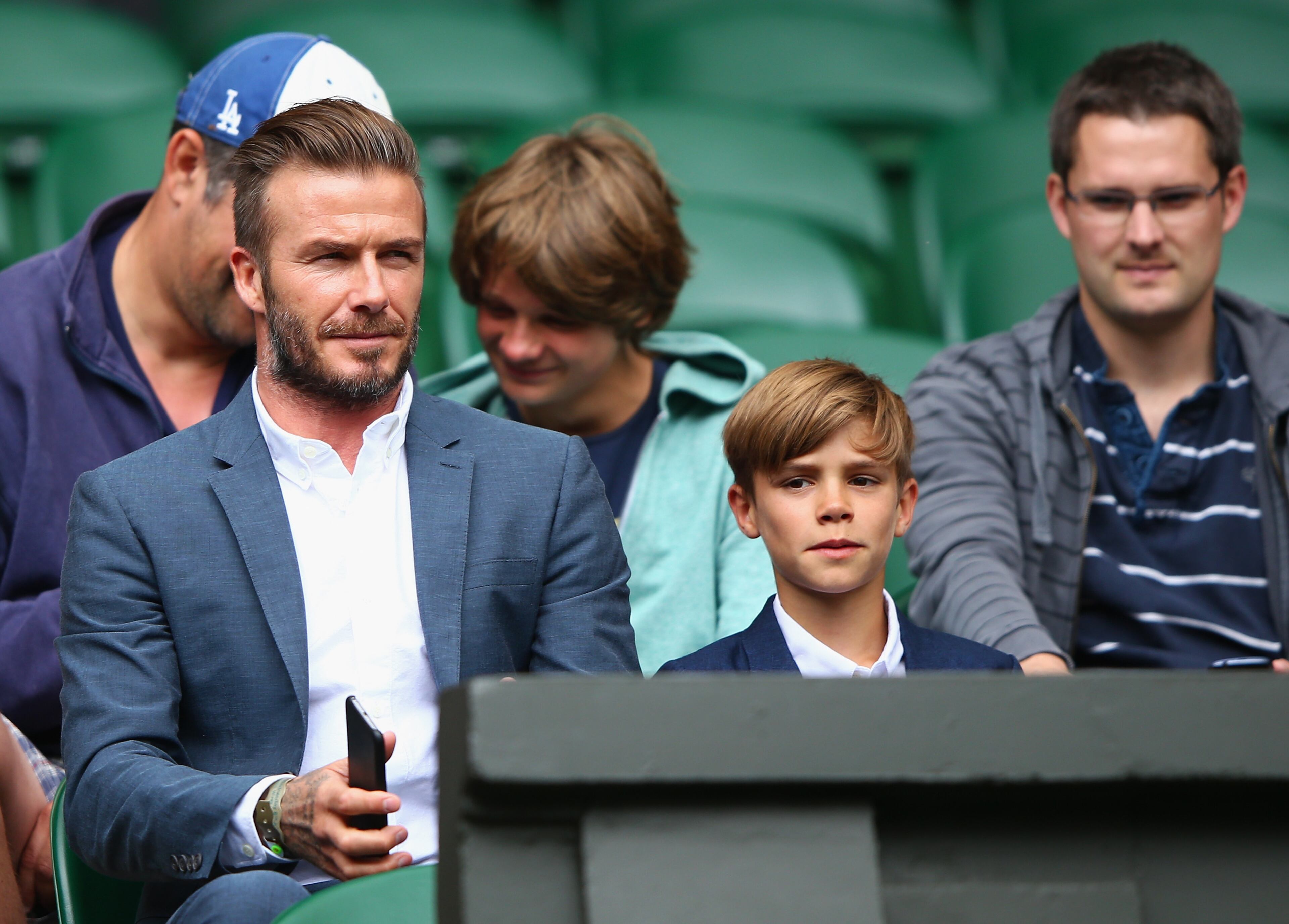 LONDON, ENGLAND - JULY 08: David Beckham and son Romeo Beckham attend day nine of the Wimbledon Lawn Tennis Championships at the All England Lawn Tennis and Croquet Club on July 8, 2015 in London, England. (Photo by Ian Walton/Getty Images)