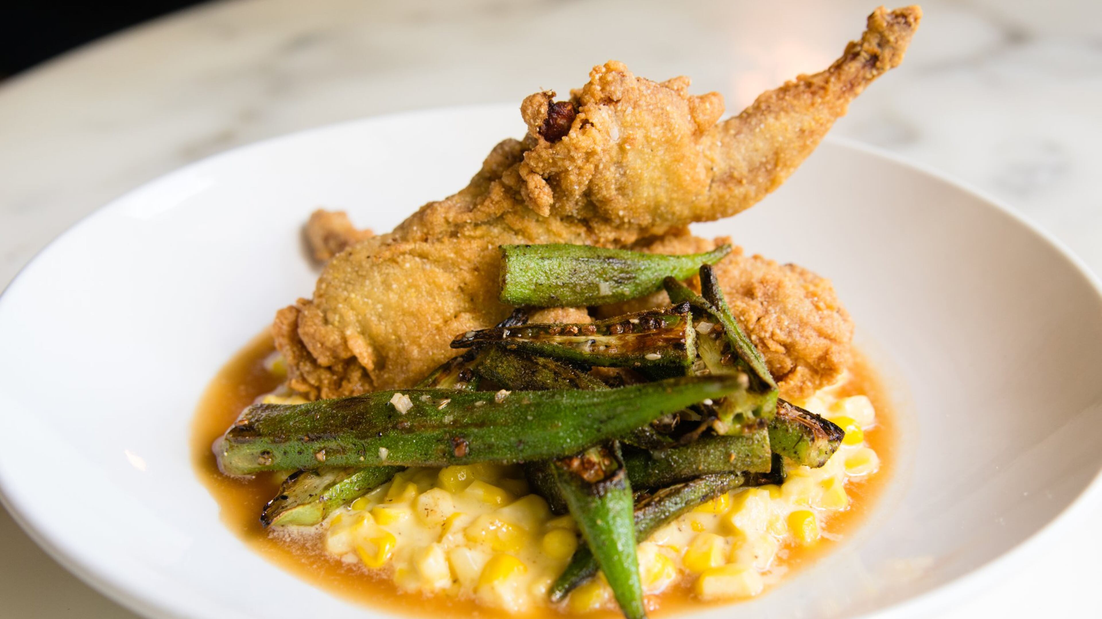 Crispy fried quail with creamed corn and okra gets a kick from the Middle Eastern spice mixture za’atar. CONTRIBUTED BY HENRI HOLLIS
