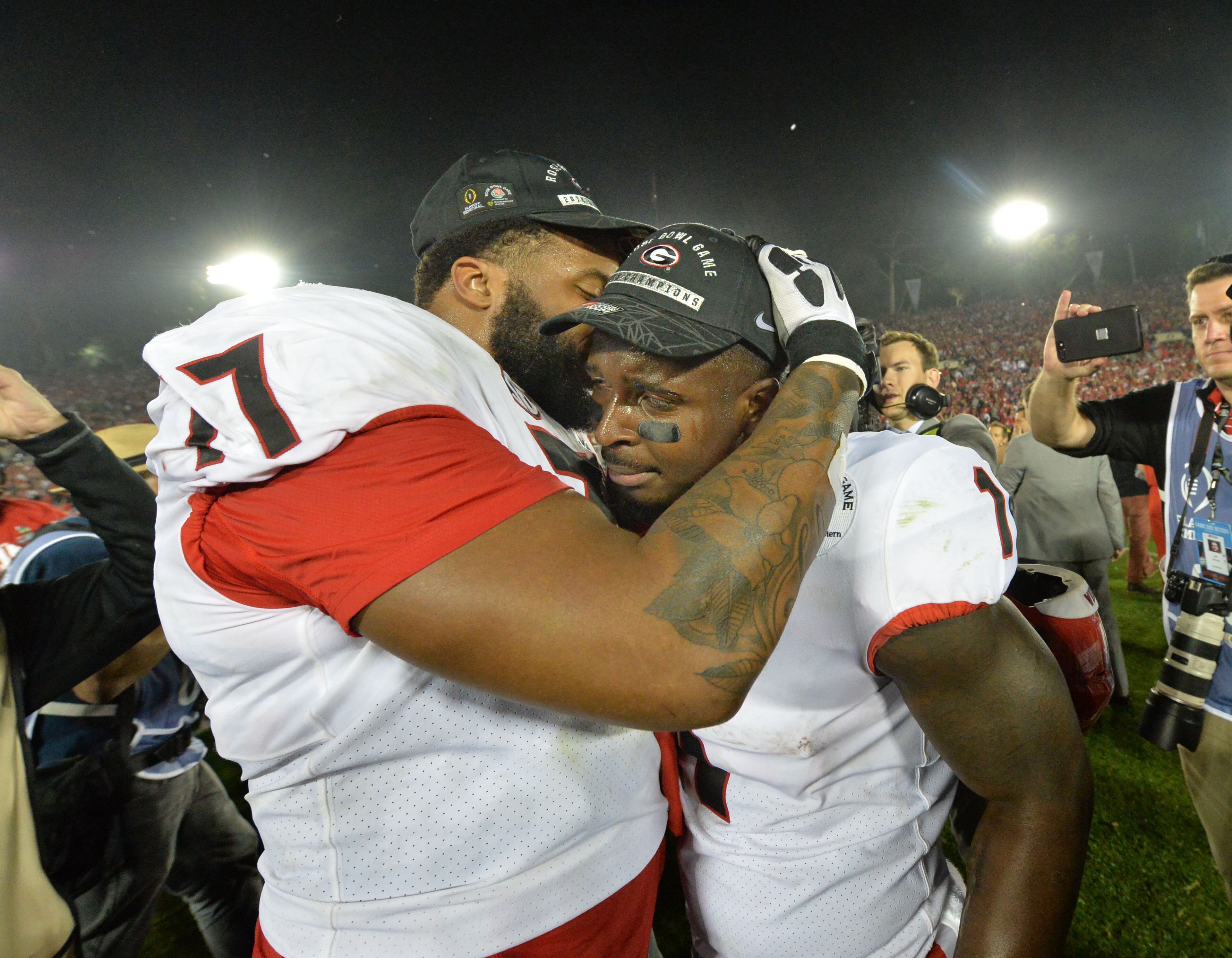 January 1, 2018 Pasadena, California - Georgia offensive tackle Isaiah Wynn (77) and Georgia running back Sony Michel (1) celebrate their victory over the Oklahoma during the College Football Playoff Semifinal between Georgia and Oklahoma at Rose Bowl Stadium in Pasadena, California on Monday, January 1, 2018. Hyosub Shin / hshin@ajc.com