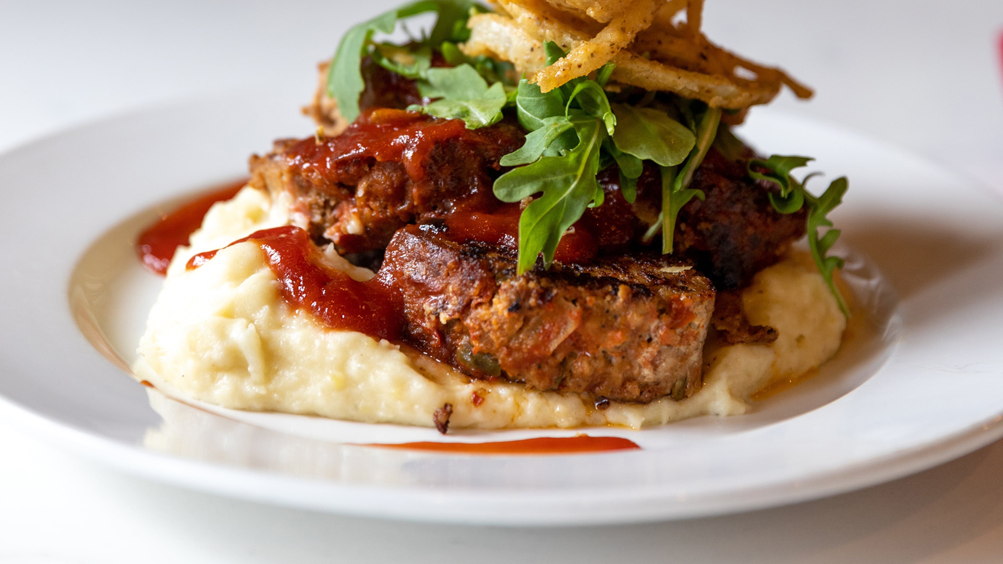 Joy Cafe's Meatloaf with Garlic Mashed Potatoes and Crispy Onion Straws
Courtesy of Atlys Media