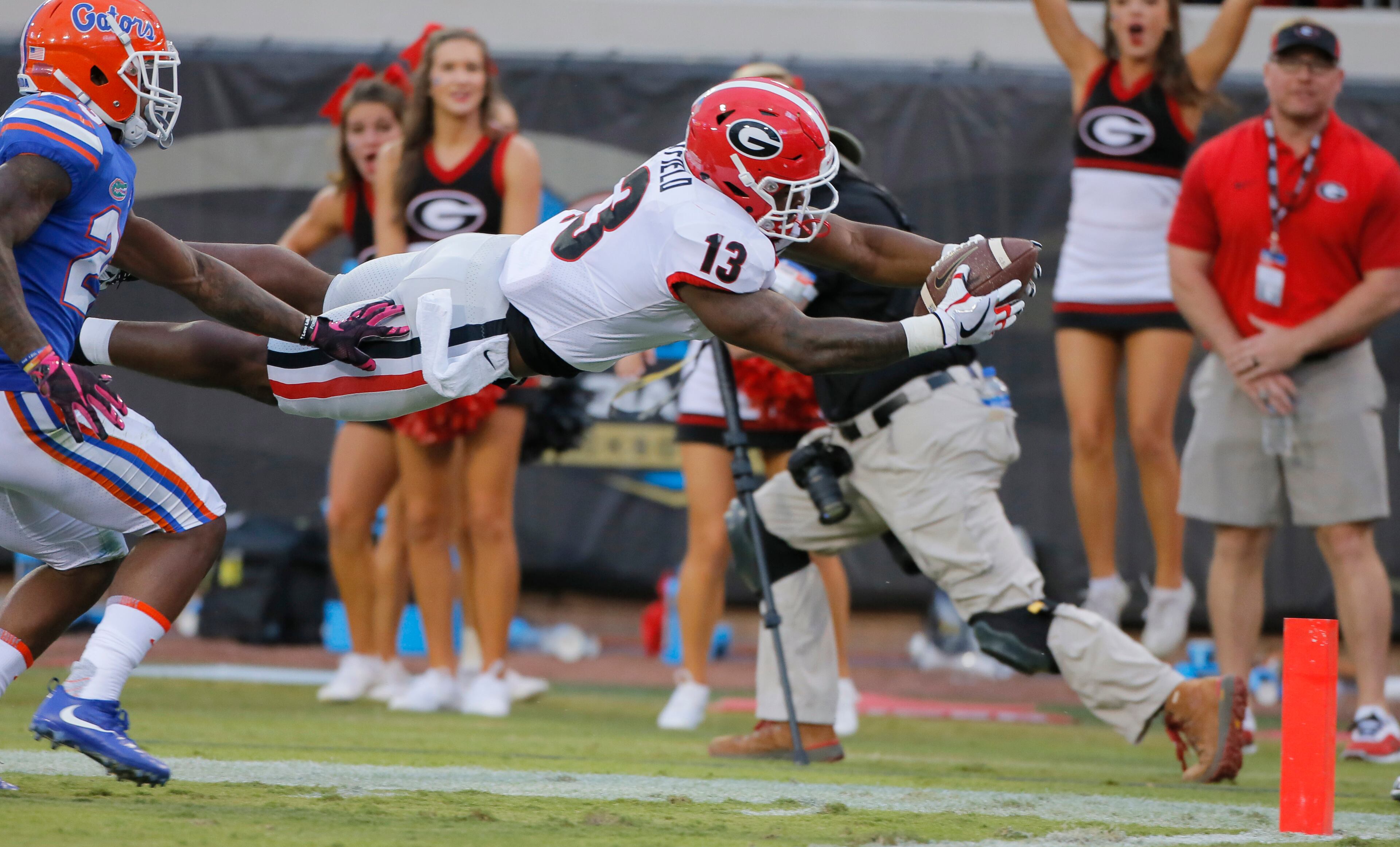 10/28/17 - Jacksonville, FL - Georgia Bulldogs running back Elijah Holyfield (13) dives for a TD after a long second half run during the second half. NCAA football game between Georgia and Florida at EverBank Field in Jacksonville. Georgia defeated Florida 42-7. BOB ANDRES /BANDRES@AJC.COM