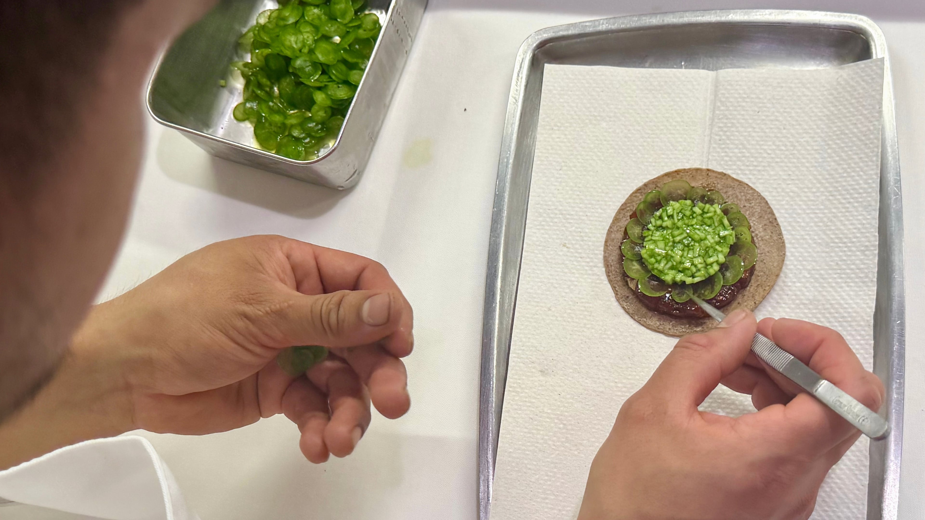 A tostada with bluefin tuna is prepared at Californios in San Francisco on Thursday, July 16, 2026. (AP Photo/Haven Daley)