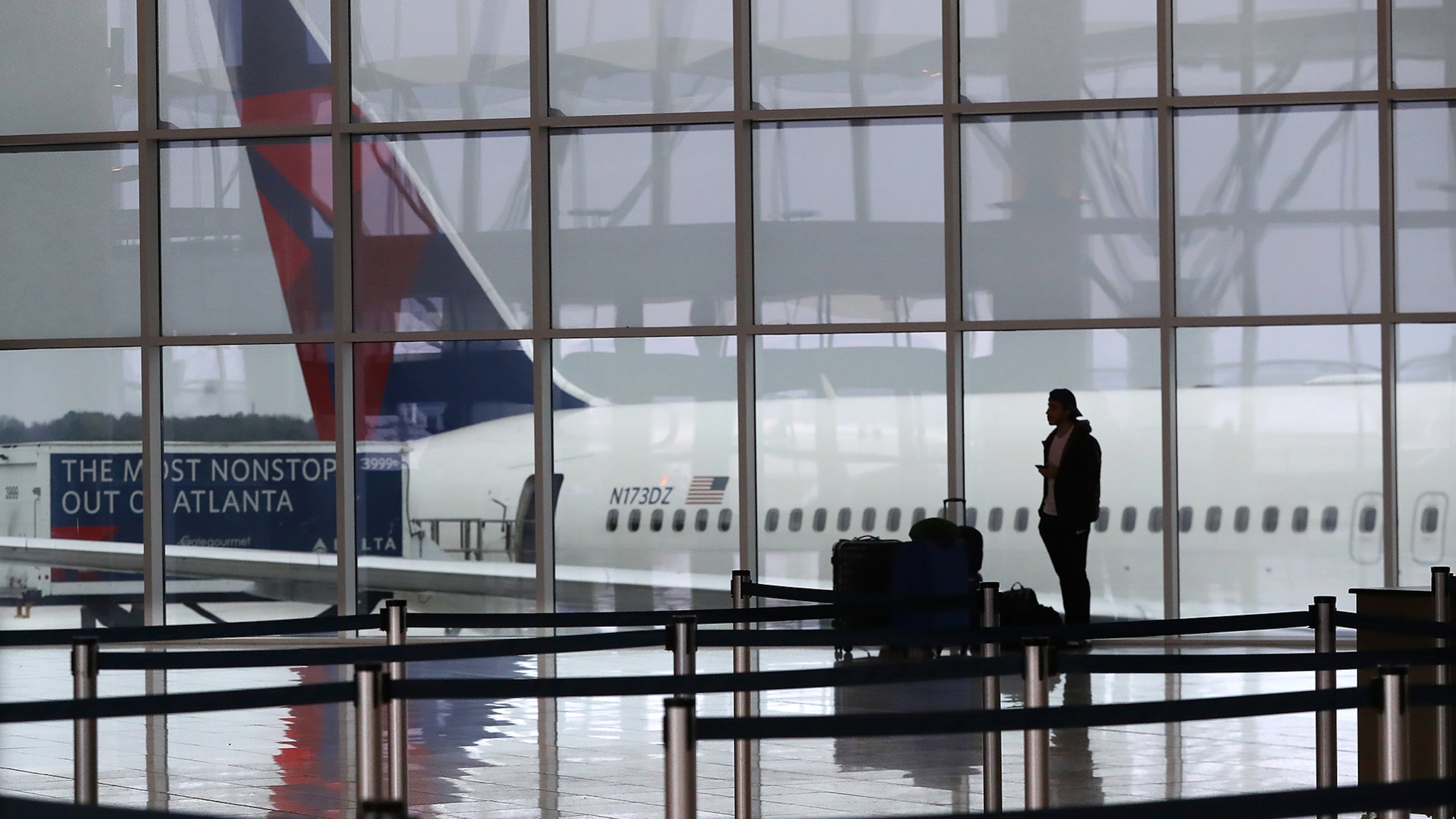 March 16, 2020 Atlanta: A Delta plane sits at the International Terminal at Hartsfield Jackson International Airport with a solitary international traveler trying to get a flight home amid new European travel restrictions on Monday, March 16, 2020, in Atlanta. International and domestic air travel has been hammered by the coronavirus. Curtis Compton ccompton@ajc.com