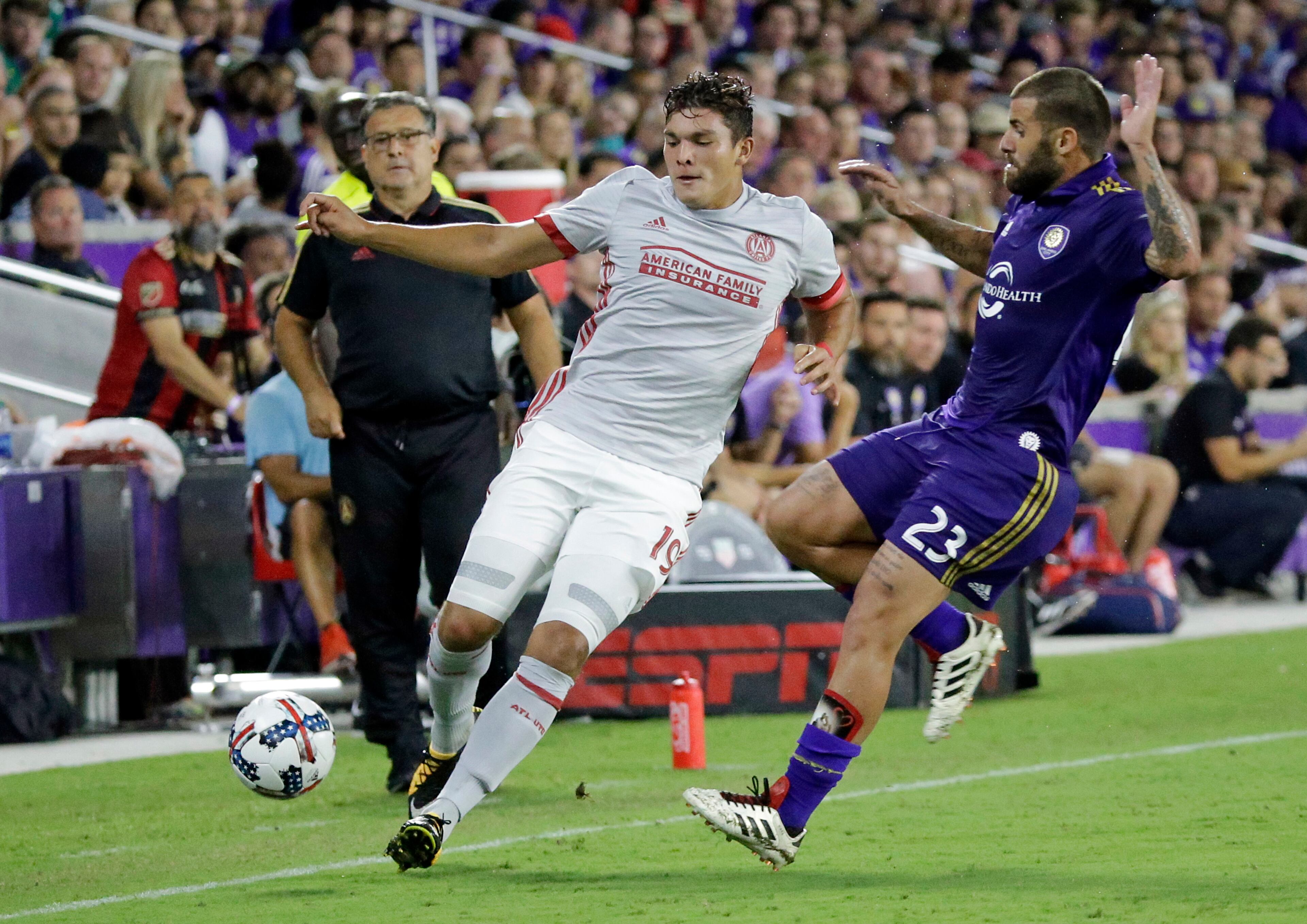 Atlanta United's Brandon Vazquez, left, and Orlando City's Antonio Nocerino (23) fight for possession of the ball during the second half of an MLS soccer match, Friday, July 21, 2017, in Orlando, Fla. Atlanta United won 1-0. (AP Photo/John Raoux)