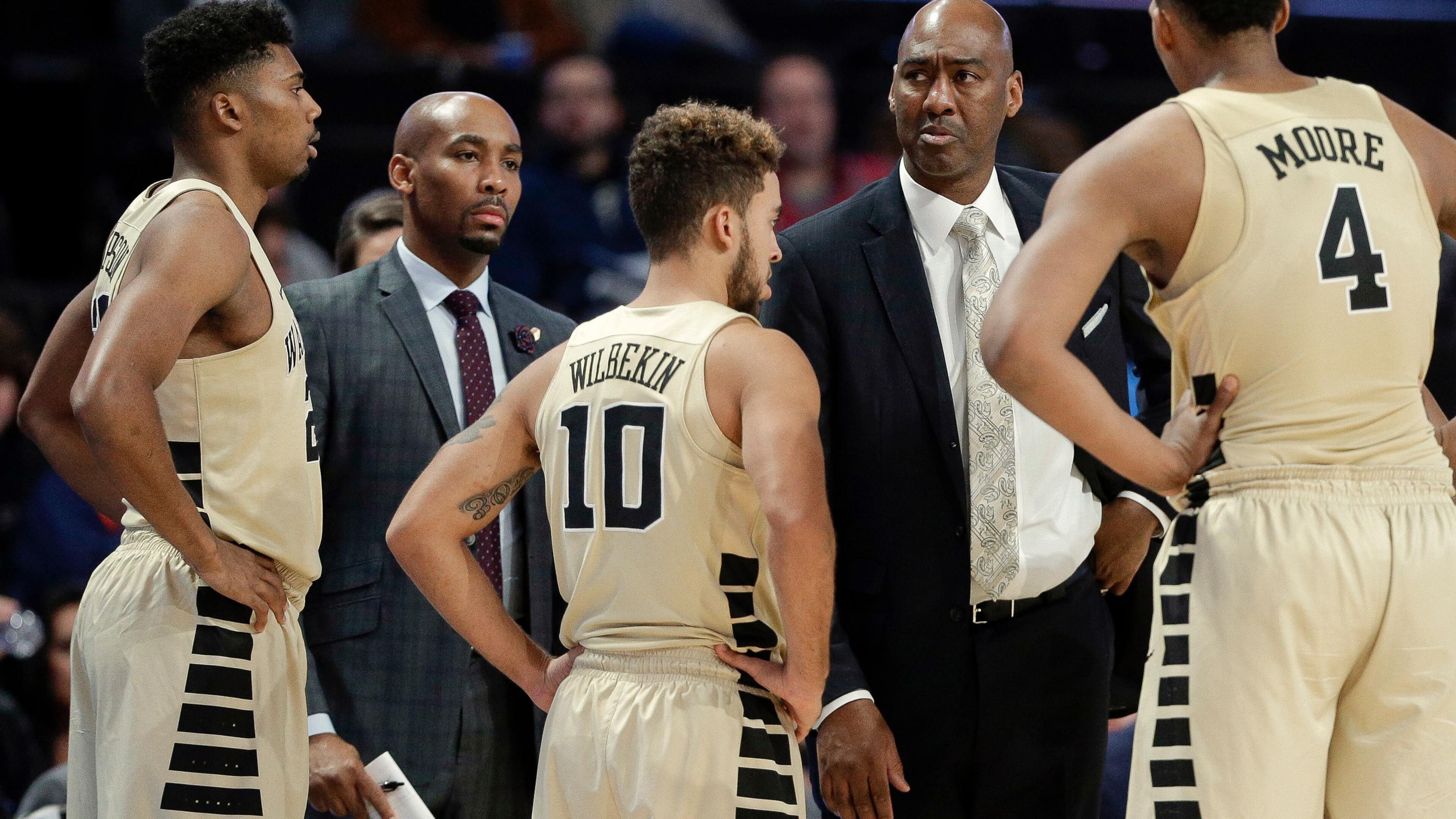 Wake Forest assistant coach Jamill Jones, second from left,was arrested after police said he threw a punch that killed a New York City tourist.