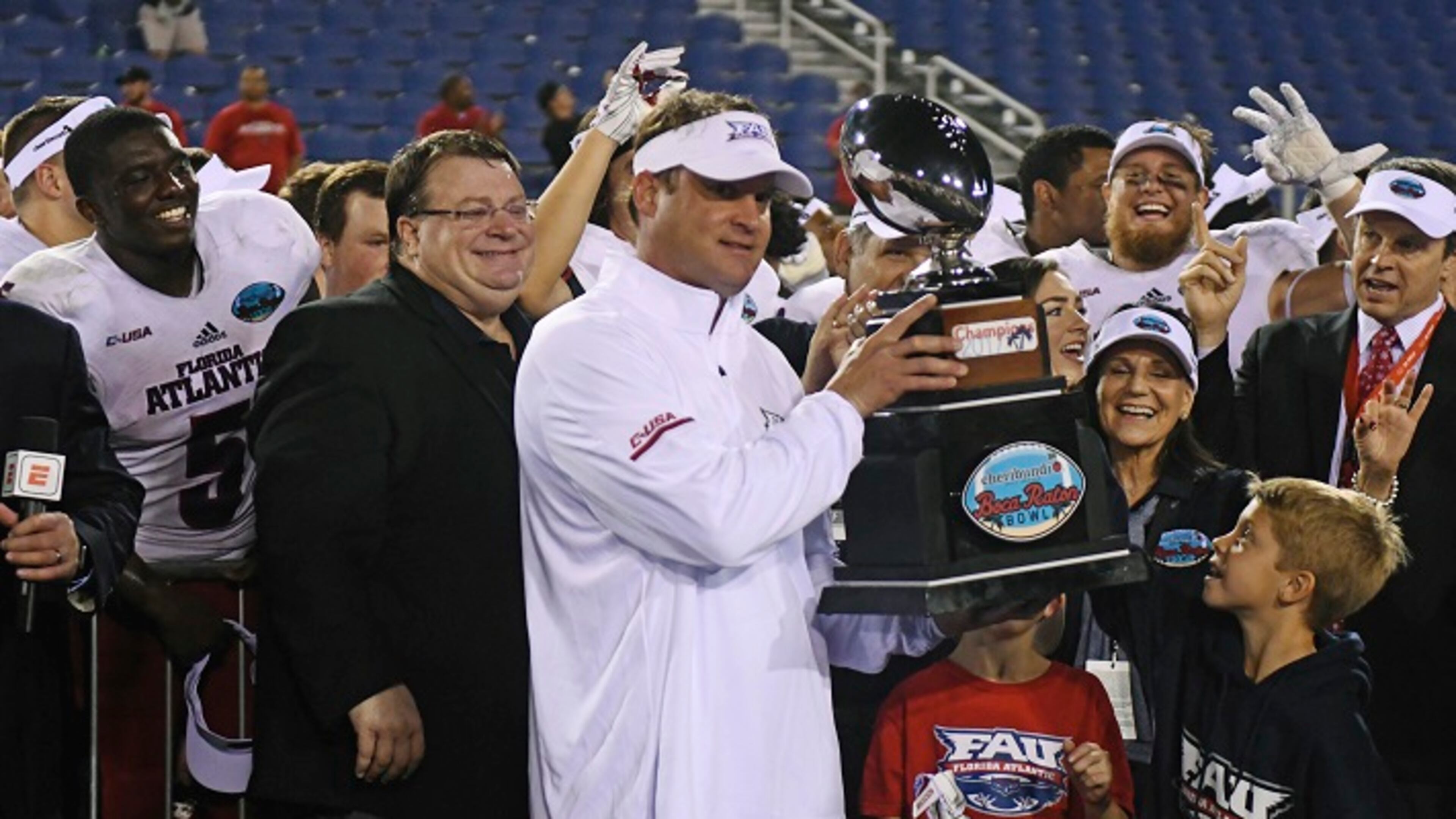 Florida Atlantic head coach Lane Kiffin holds the Boca Raton Bowl trophy after beating Akron 50-3 in an NCAA college football game in Boca Raton, Fla., Tuesday, Dec. 19, 2017. (Jim Rassol/South Florida Sun-Sentinel via AP)