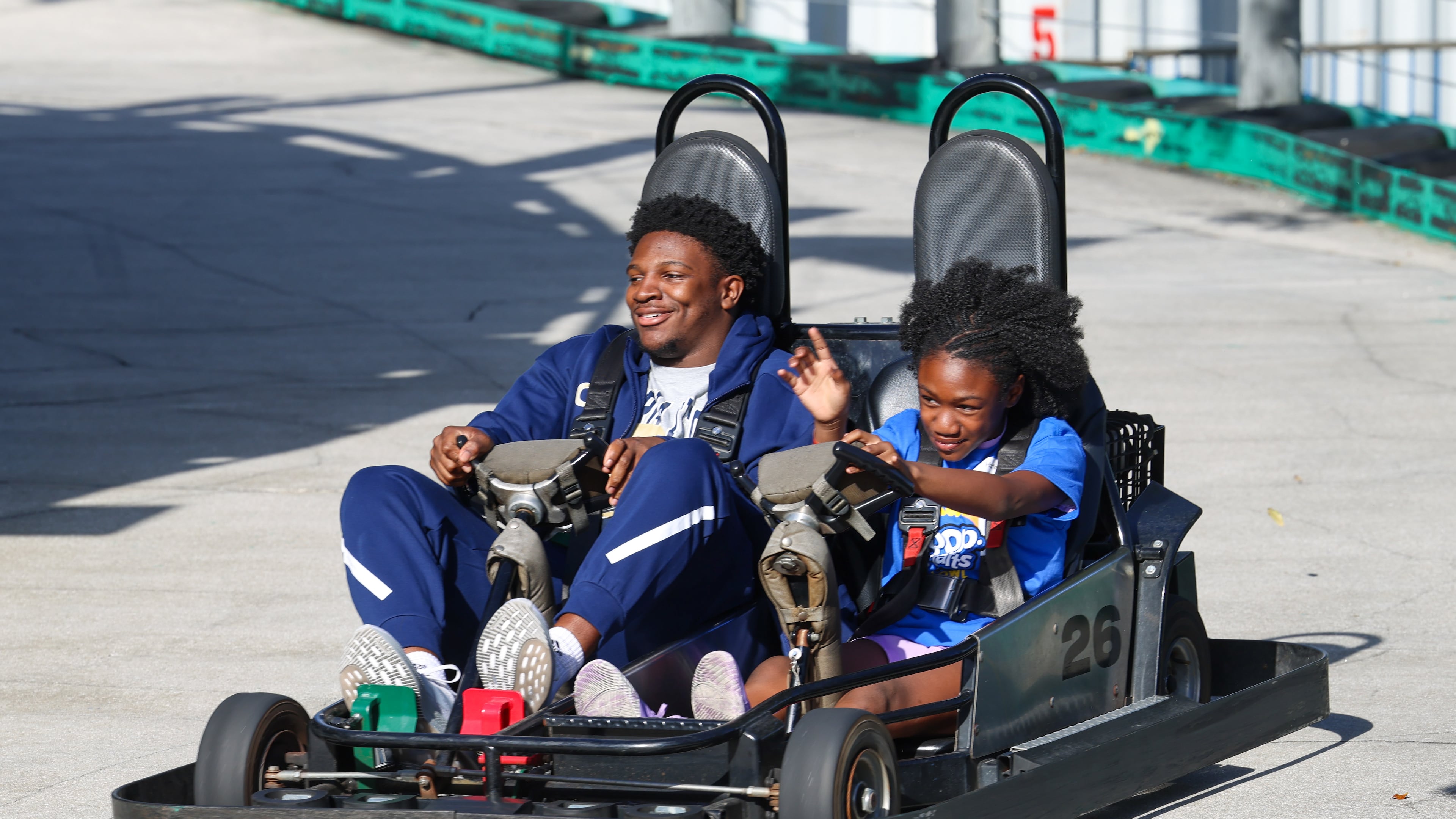 Georgia Tech football player Chuma Okoye rides along with a local child during Pop-Tarts Bowl festivities at Fun Spot America on Tuesday, Dec. 23, 2025, in Orlando, Fla. (Don Montague/Florida Citrus Sports)