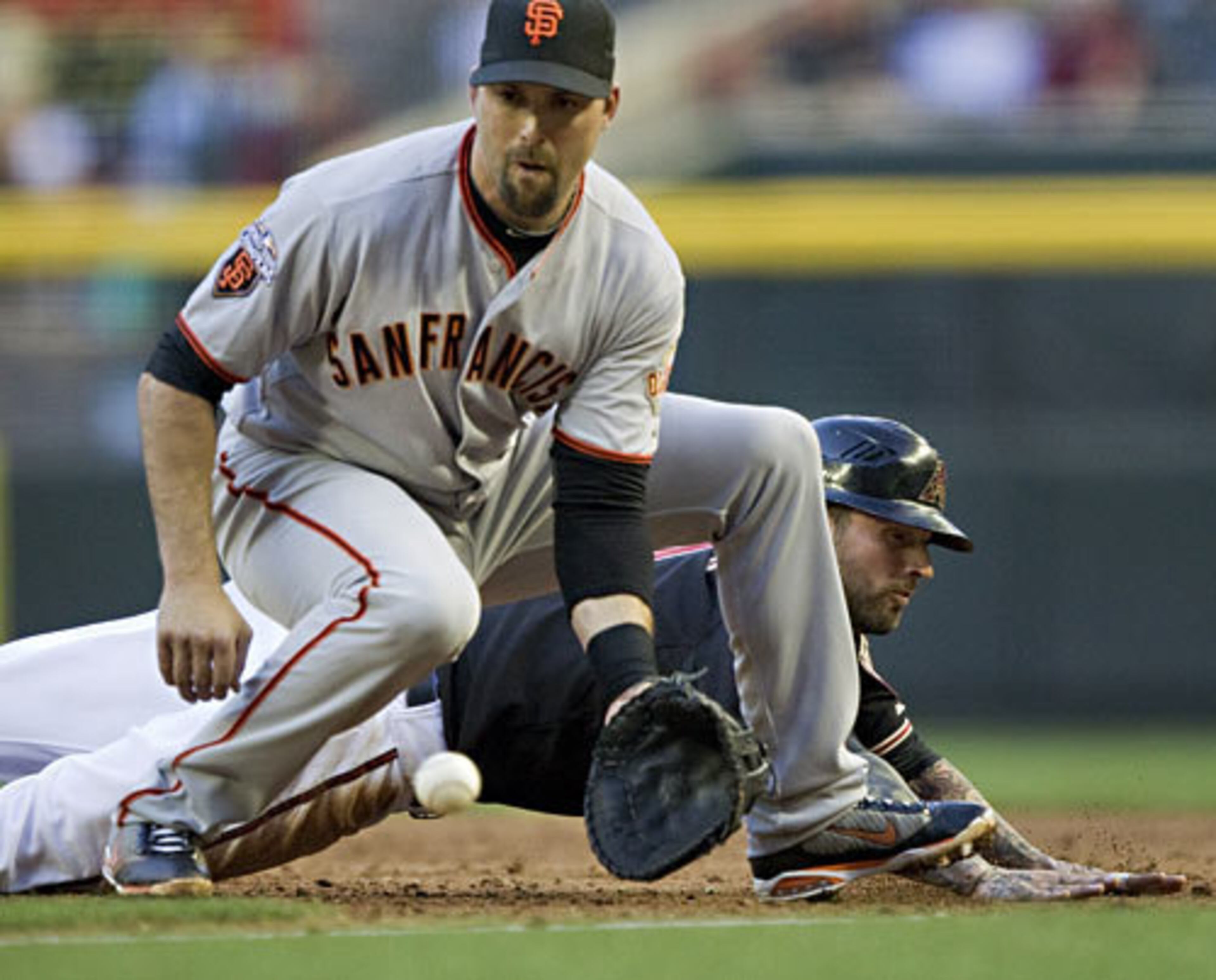 MARK DeROSA (front) and the Giants look to repeat as World Series champs this season. DeRosa is getting things off to a good start, posting 3 RBI and a .429 average to date.