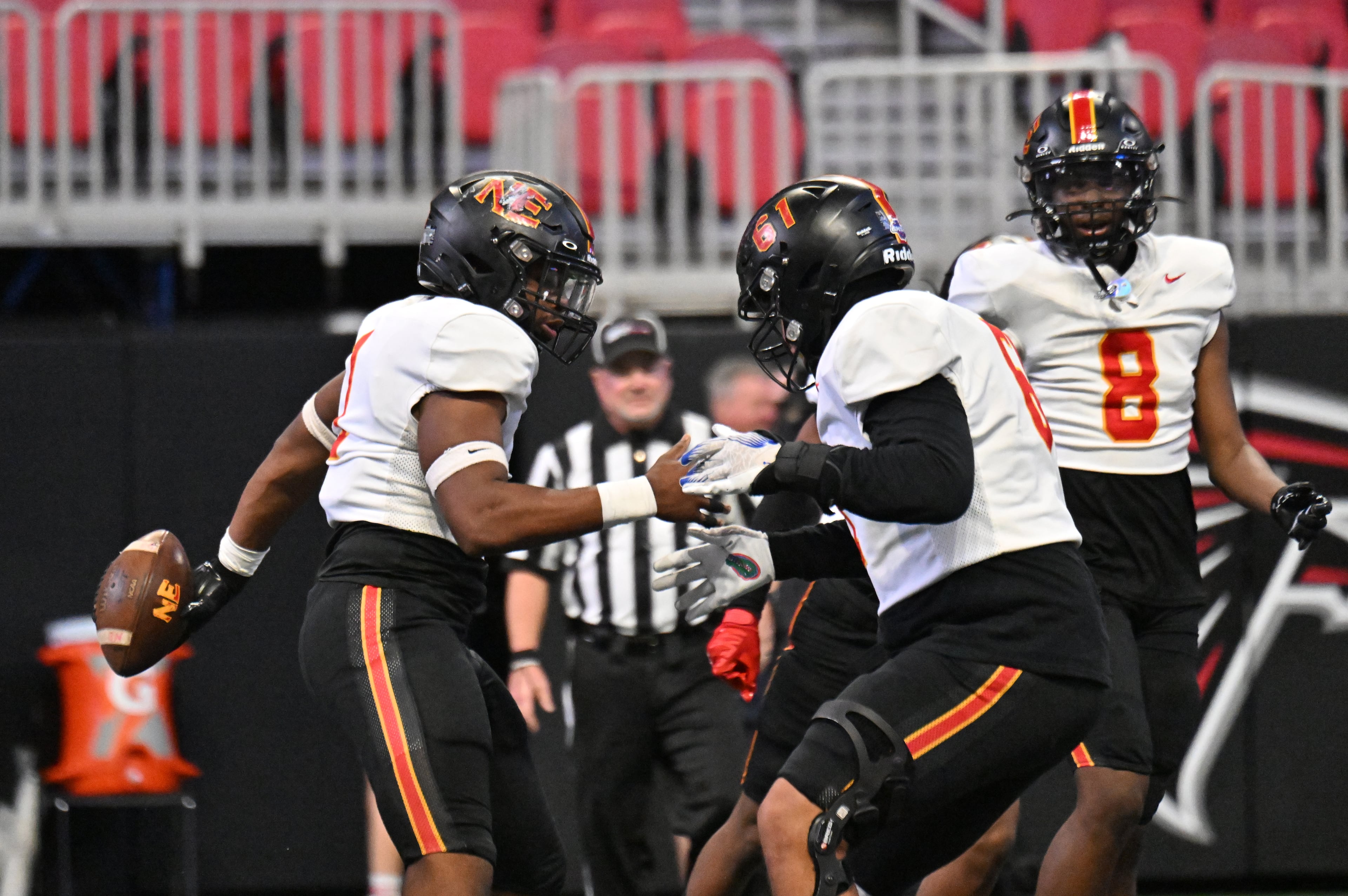 Northeast's tackle Isaiah Stubbs (1) celebrates with Northeast's defensive end Jared Cooper (61) after scoring a touchdown tduring the first half in GHSA Class A-Division State Championship game at Mercedes-Benz Stadium, Tuesday, December 17, 2024, in Atlanta. (Hyosub Shin / AJC)