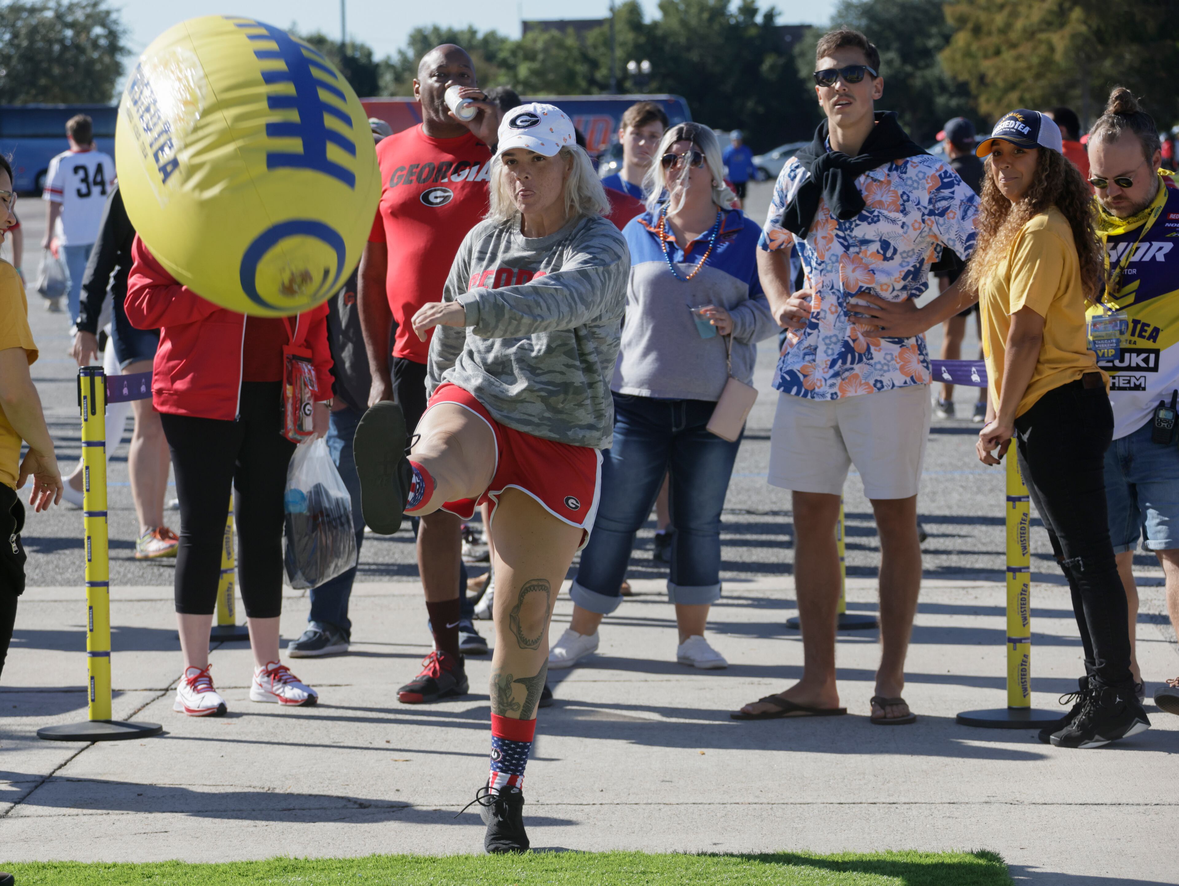 10/30/21 - Jacksonville - Fans kick a giant inflatable football at one of the fan events before the annual NCCA Georgia vs Florida game at TIAA Bank Field in Jacksonville. Bob Andres / bandres@ajc.com