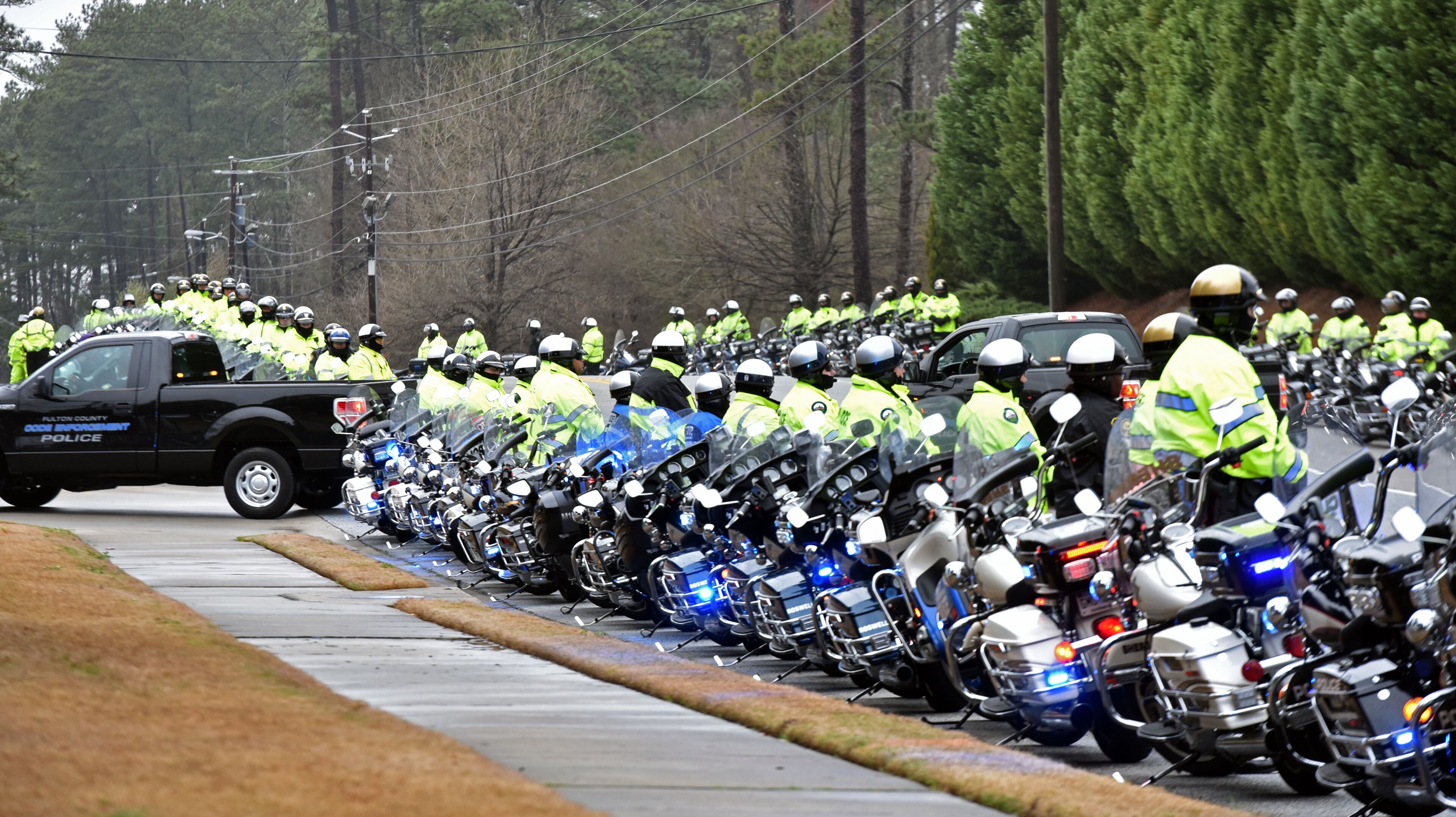 Law enforcement procession arrives at World Changers International Church to honor and attend the funeral of Fulton County Detective Terence Green, who killed in an ambush, on Friday, March 13, 2015. Terence Avery Green, 48, was on duty March 4 when he was killed in what a Fulton police assistant chief called an ambush-style attack. HYOSUB SHIN / HSHIN@AJC.COM