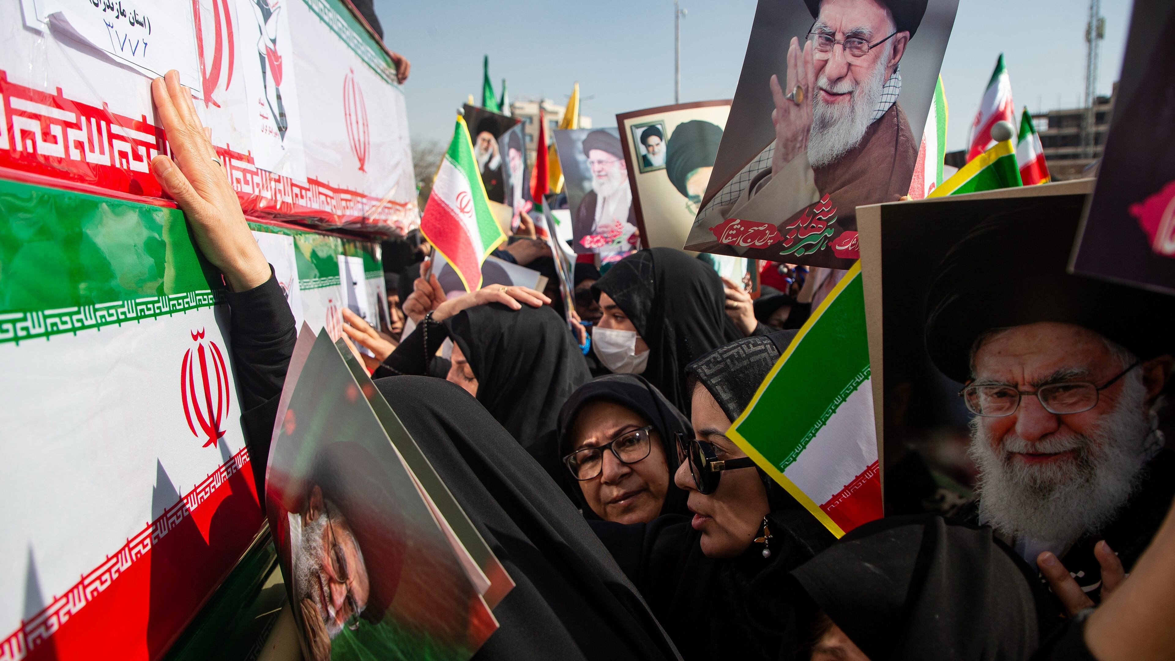 Some holding pictures of the late Iranian Supreme Leader Ayatollah Ali Khamenei, mourners reach out to coffins during a funeral for people killed during the ongoing U.S.–Israeli military campaign in Isfahan, Iran, Thursday, March 5, 2026. (Payman Shahsanaei/ISNA via AP)