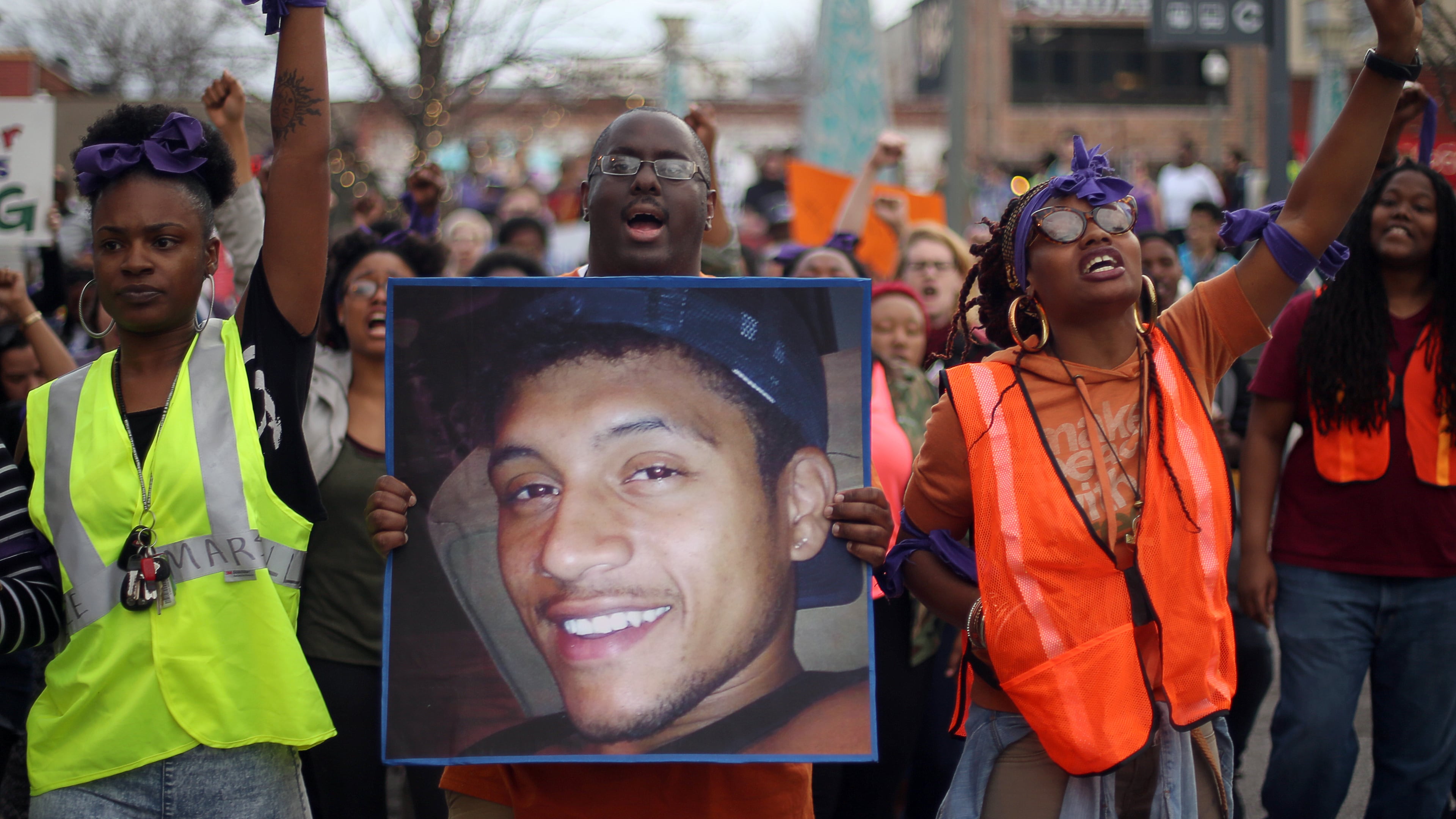March 11, 2015 Decatur: Protesters, including Brandan Marshall holding a photo of Anthony Hill, take to the streets of downtown Decatur on Wednesday evening March 12, 2015 to protest the shooting death of Hill. BEN GRAY / BGRAY@AJC.COM