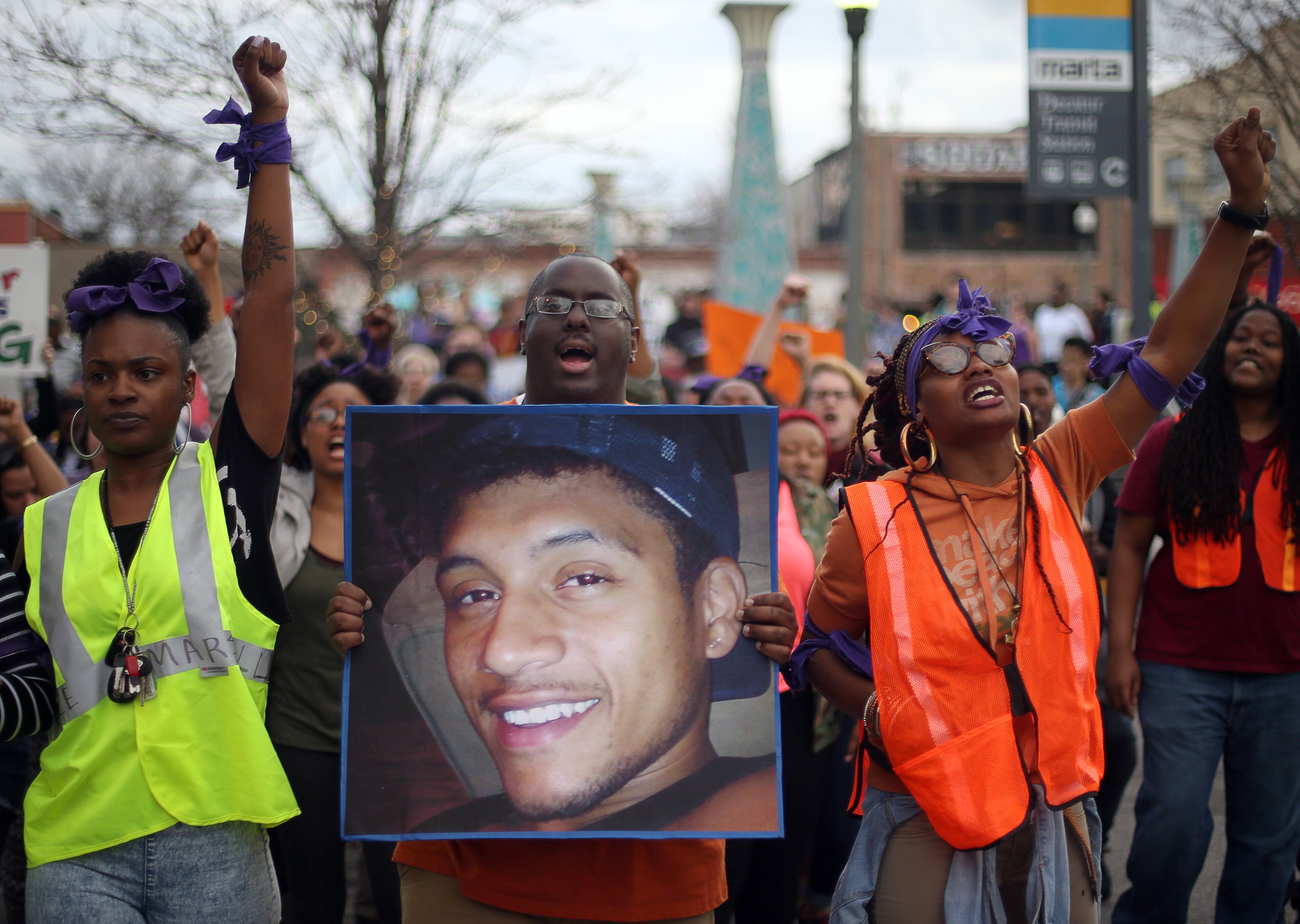 March 11, 2015 Decatur: Protesters, including Brandan Marshall holding a photo of Anthony Hill, take to the streets of downtown Decatur on Wednesday evening March 12, 2015 to protest the shooting death of Hill. BEN GRAY / BGRAY@AJC.COM