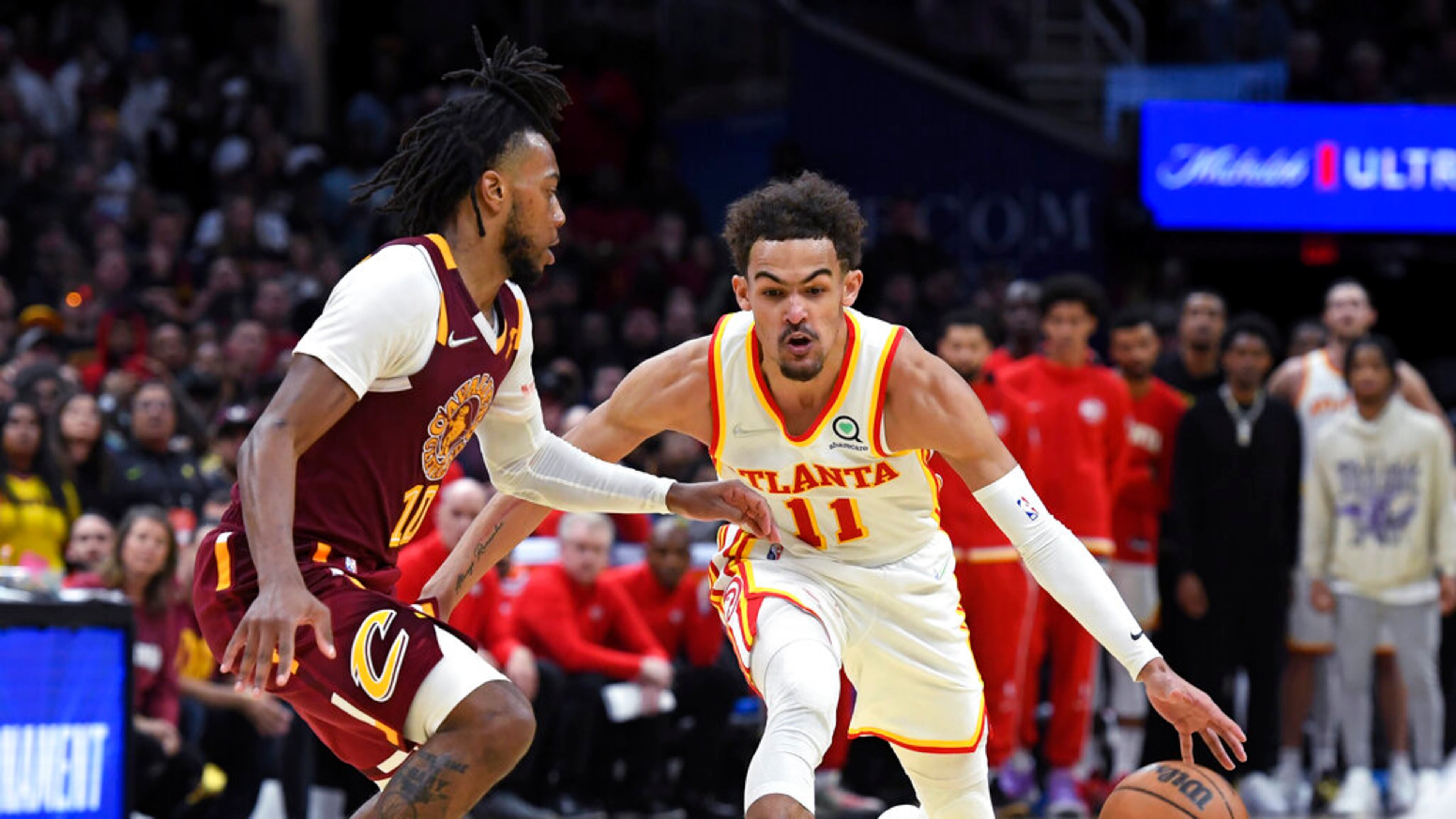 Atlanta Hawks' Trae Young (11) drives against Cleveland Cavaliers' Darius Garland (10) during the second half of an NBA play-in basketball game Friday, April 15, 2022, in Cleveland. (AP Photo/Nick Cammett)