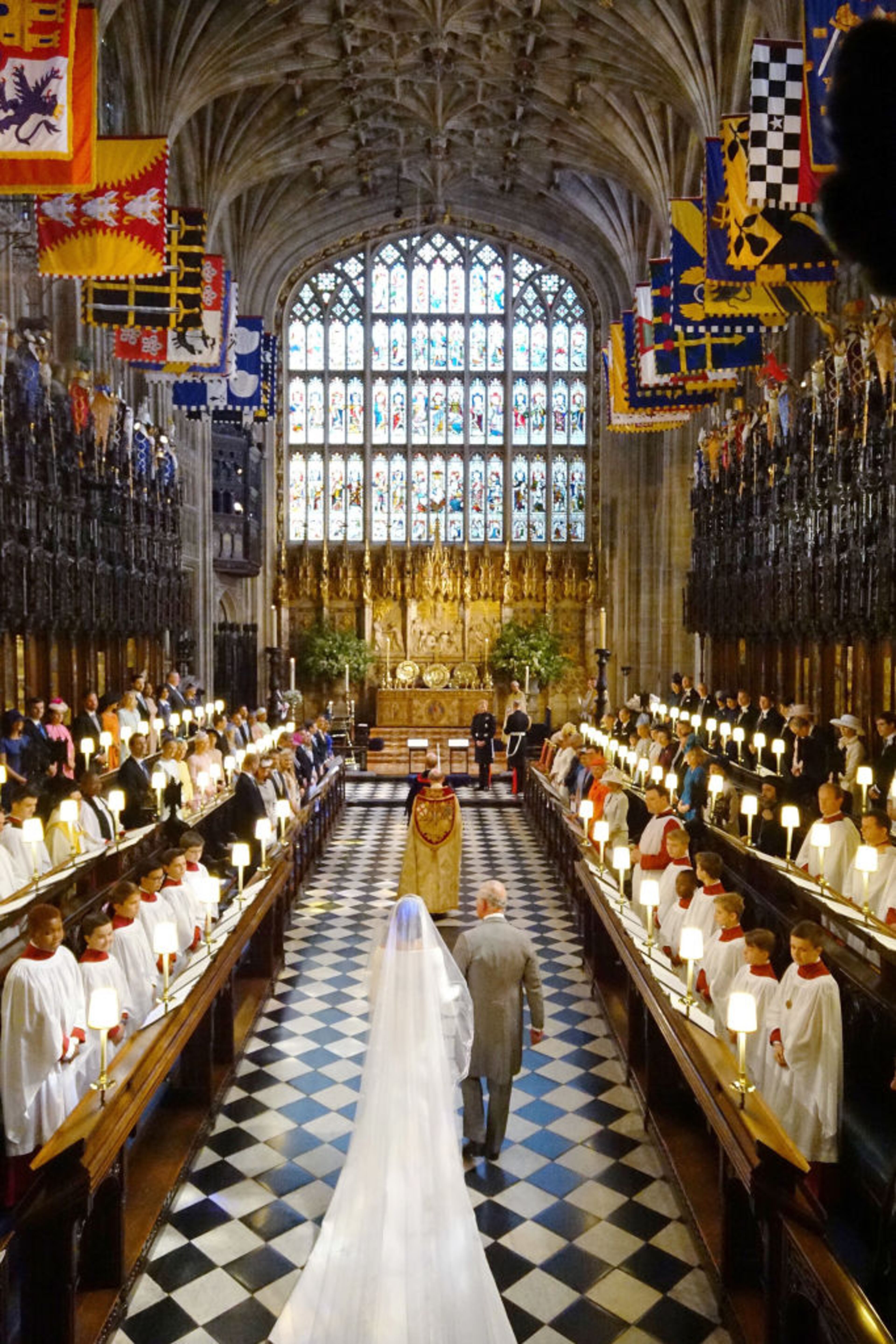 WINDSOR, UNITED KINGDOM - MAY 19: Prince Charles, Prince of Wales leads Meghan Markle up the aisle during her wedding in St George's Chapel at Windsor Castle on May 19, 2018 in Windsor, England. (Photo by Jonathan Brady - WPA Pool/Getty Images)