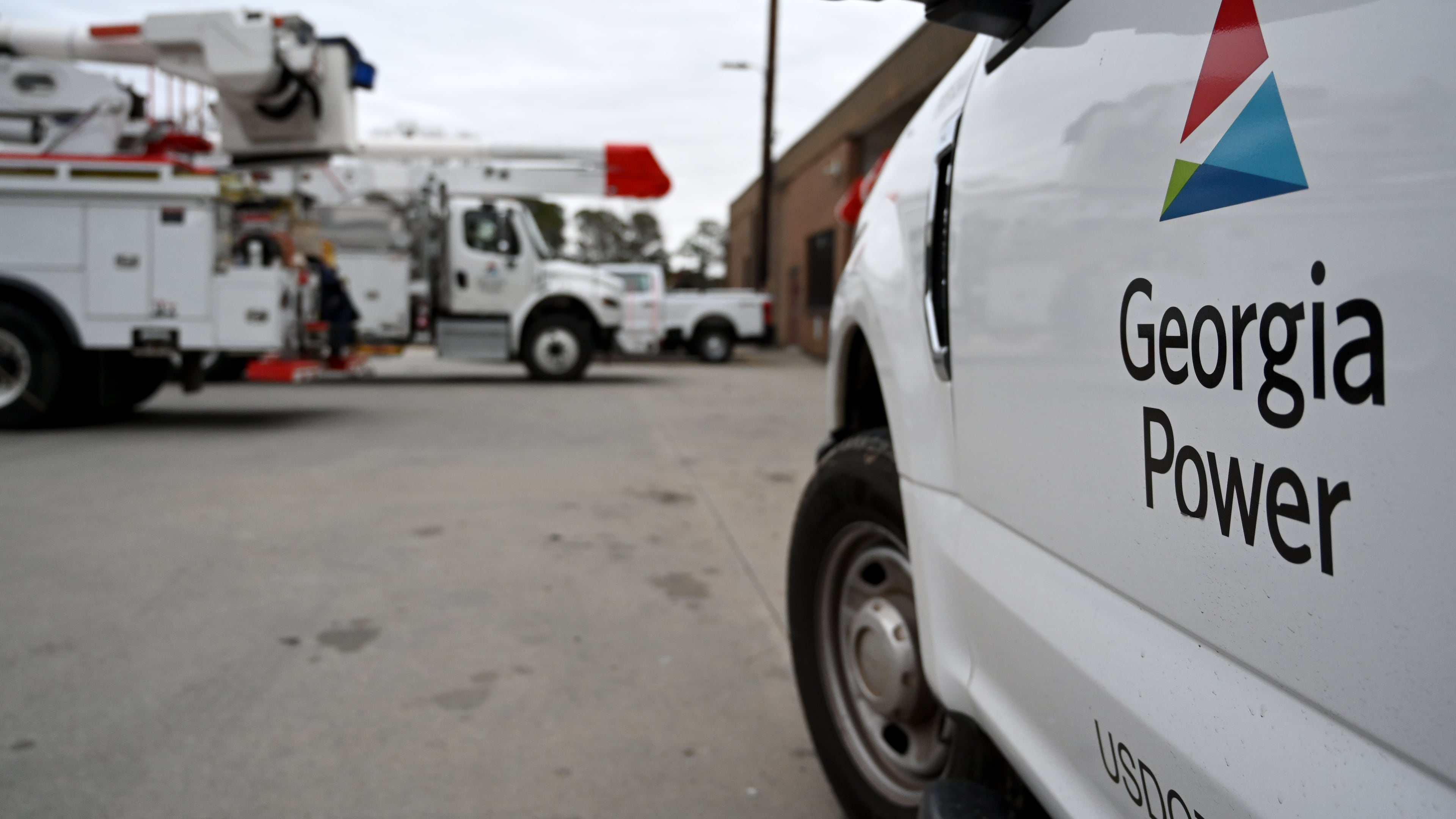 Georgia Power trucks are shown staged at a site in metro Atlanta on Saturday, Jan. 24, 2026, in Atlanta. (Hyosub Shin/AJC)